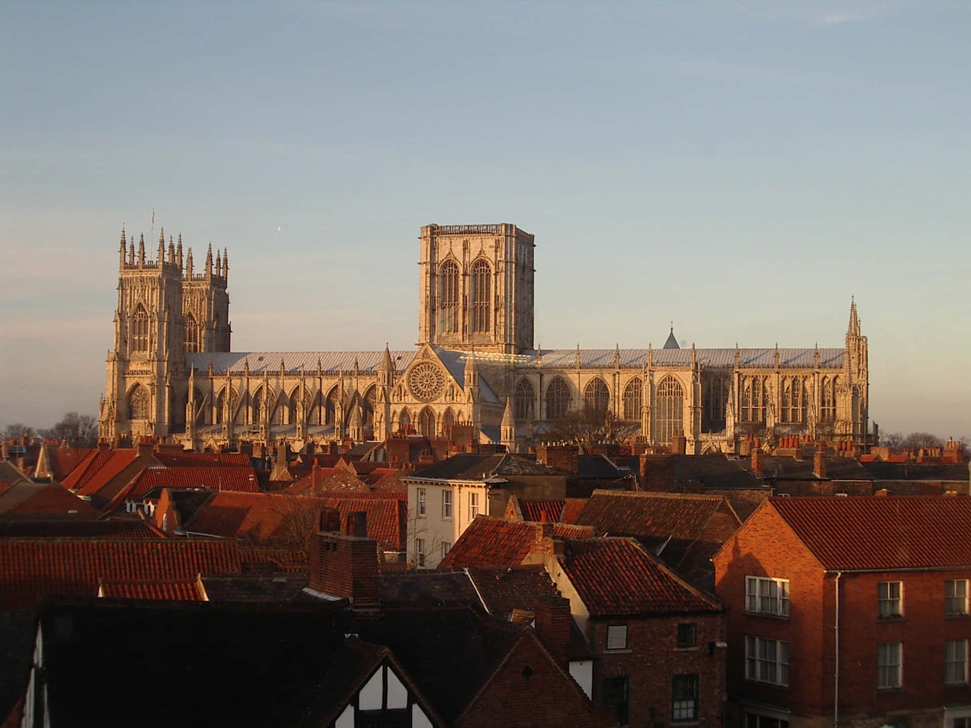 Majestic York Minster Cathedral Surrounded By A Sea Of Buildings Background