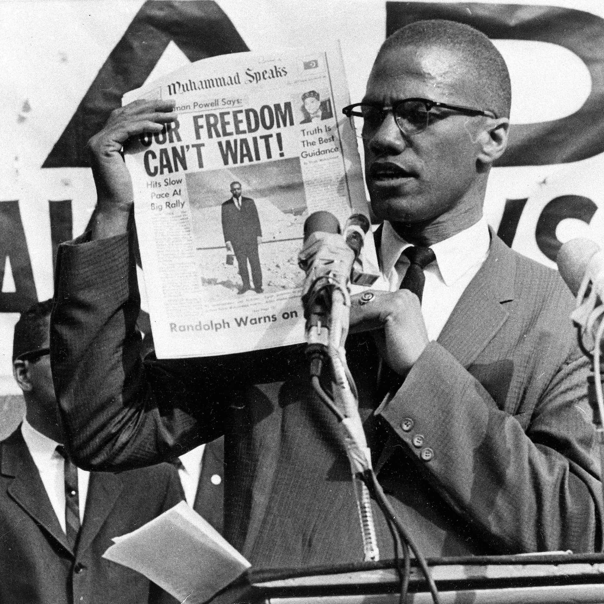Malcolm X Holding Newspaper Background