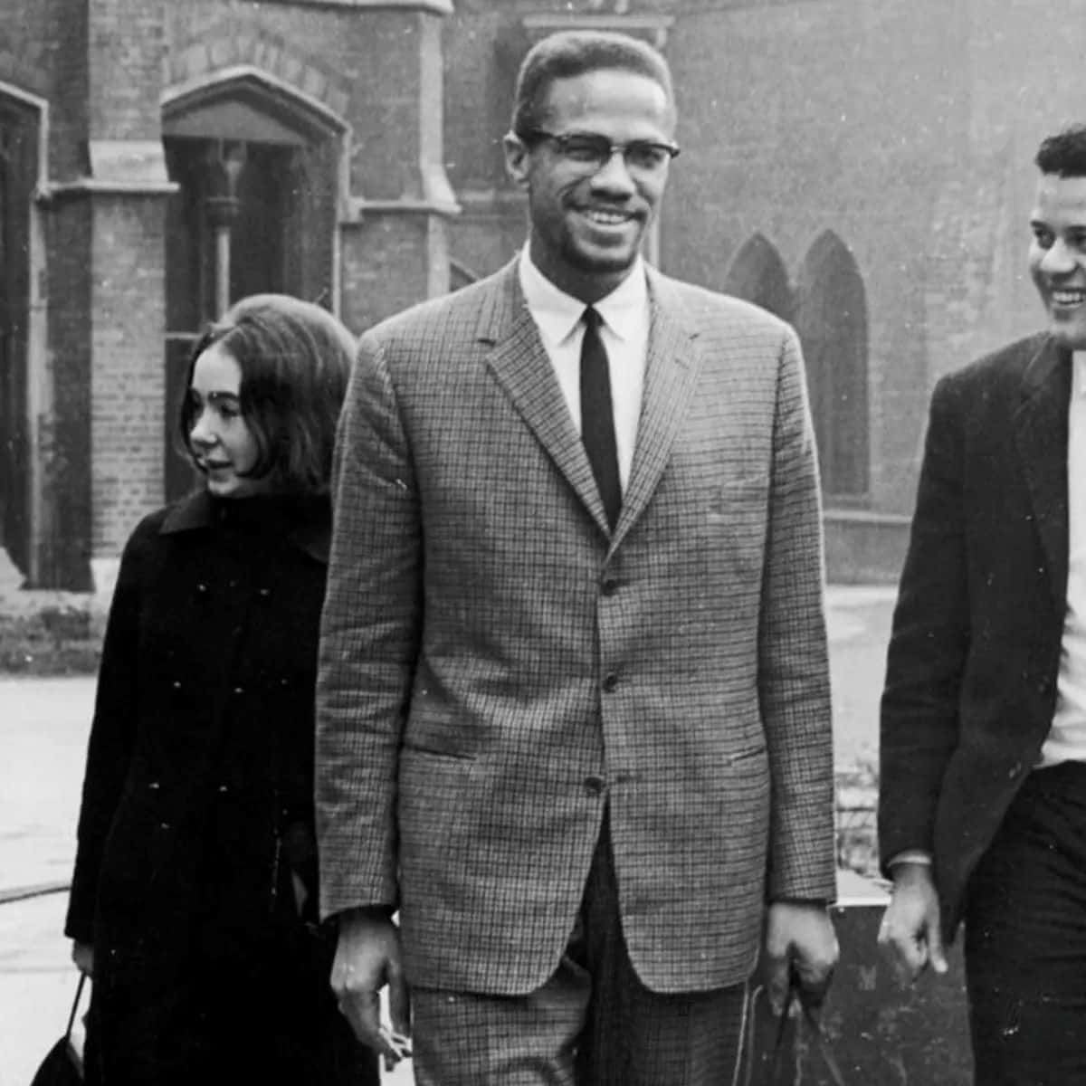 Malcolm_ X_ Smiling_with_ Companions Background