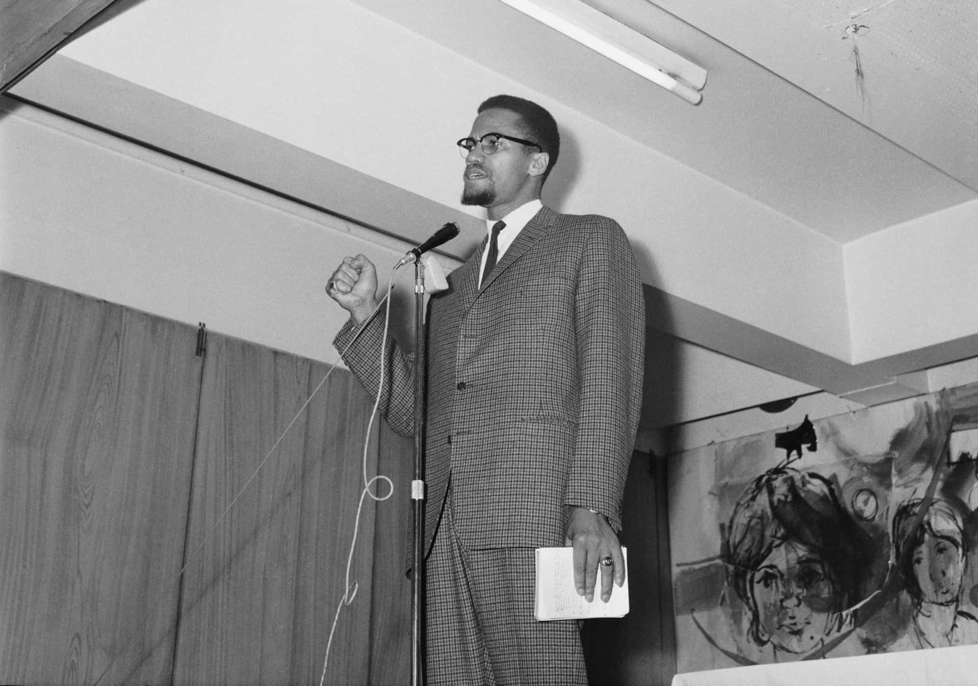 Malcolm_ X_ Speaking_at_ Podium Background