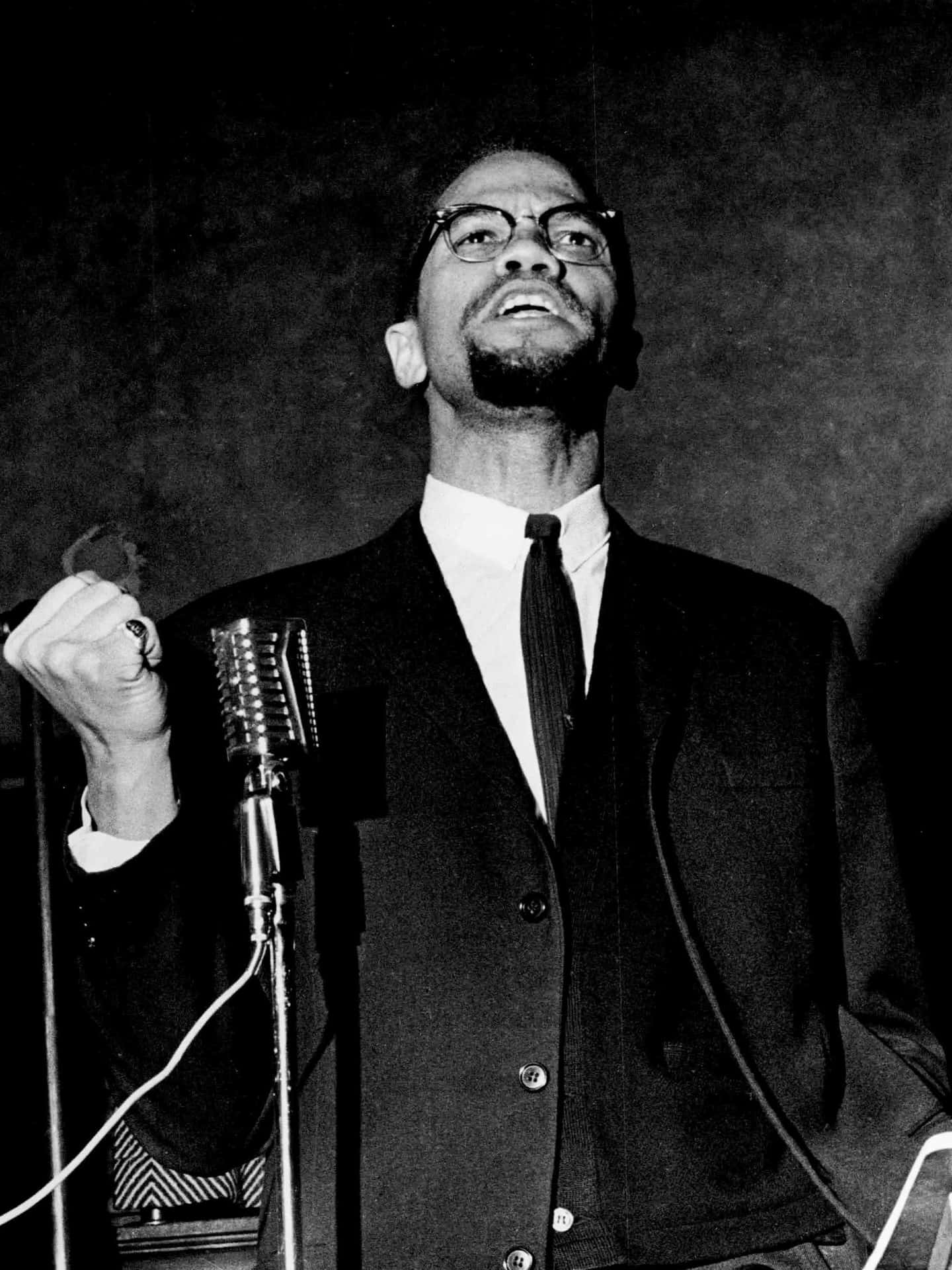 Malcolm X Speakingat Podium Background