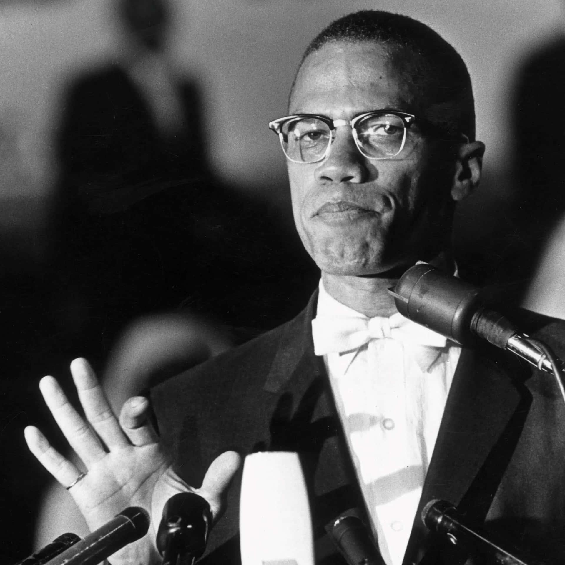 Malcolm X Speakingat Podium Background