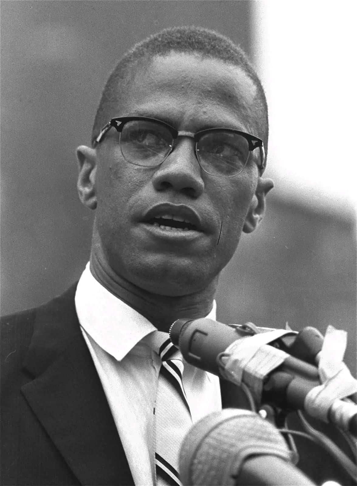 Malcolm X Speakingat Podium Background