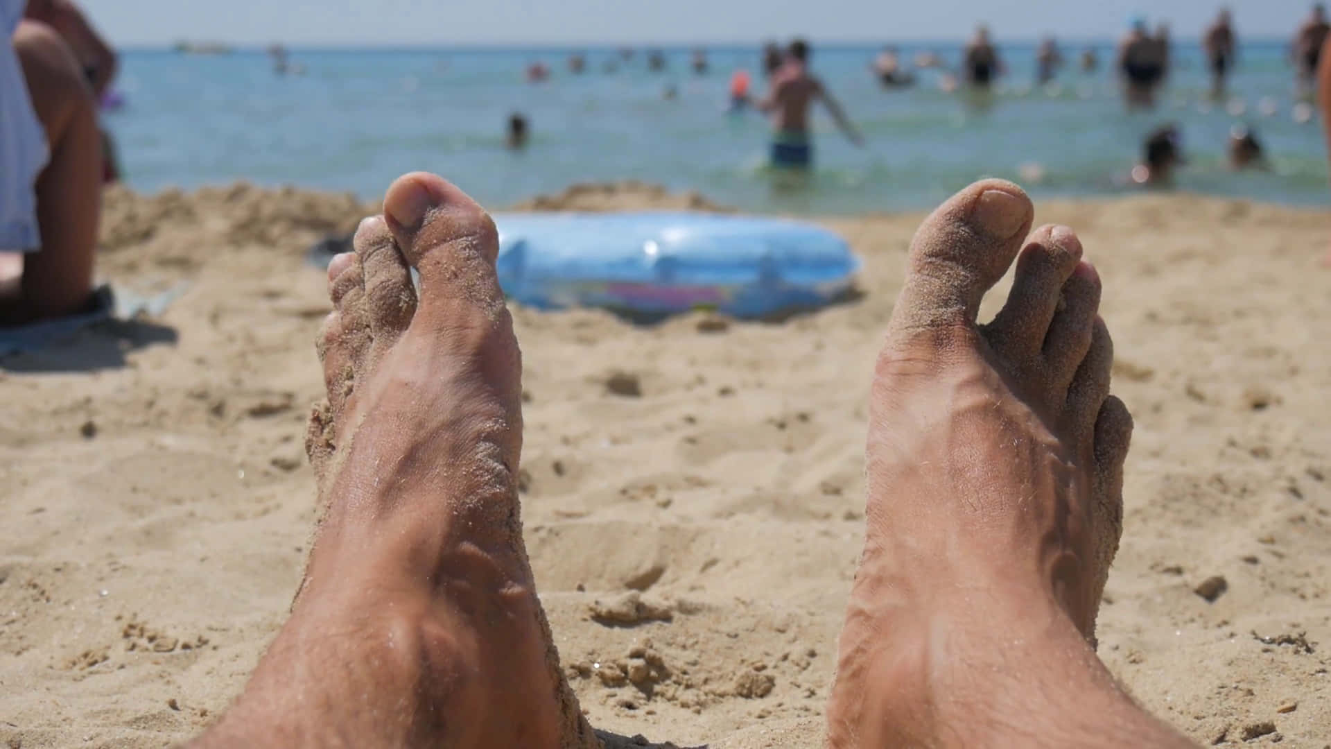 Male Feet On A Beach Background