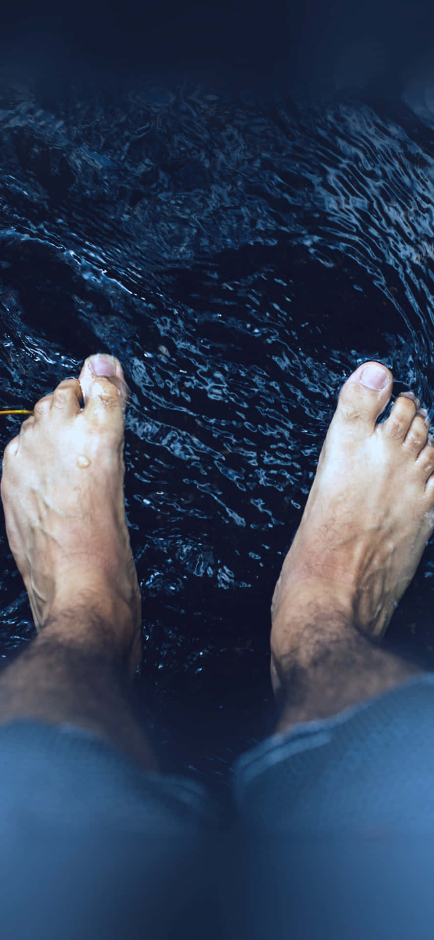 Male Feet On The Stream Background