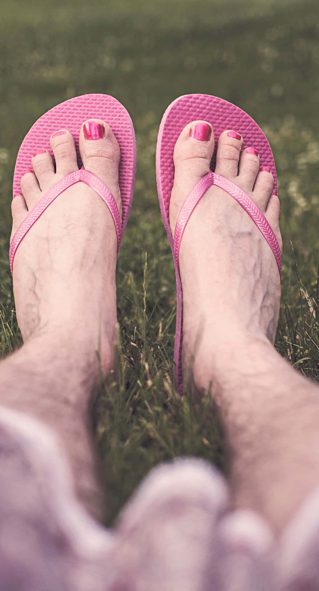 Male Feet With Pink Nail Polish And Slippers