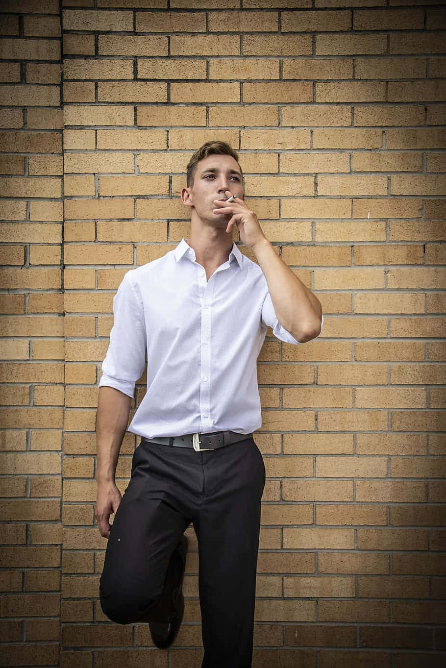 Male Model Smoking Brick Wall Background