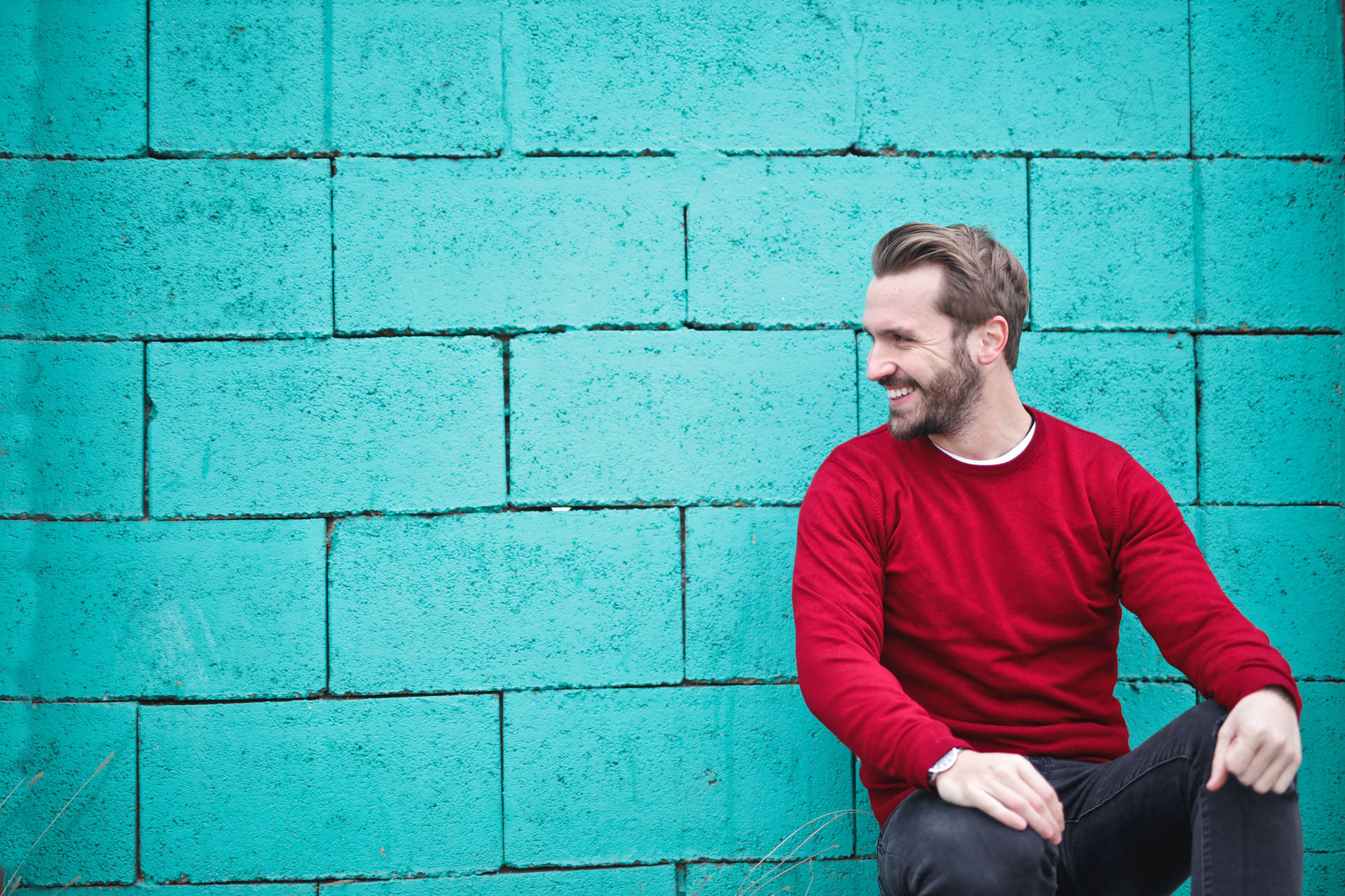 Male Pose Against Blue Brick Wall Background