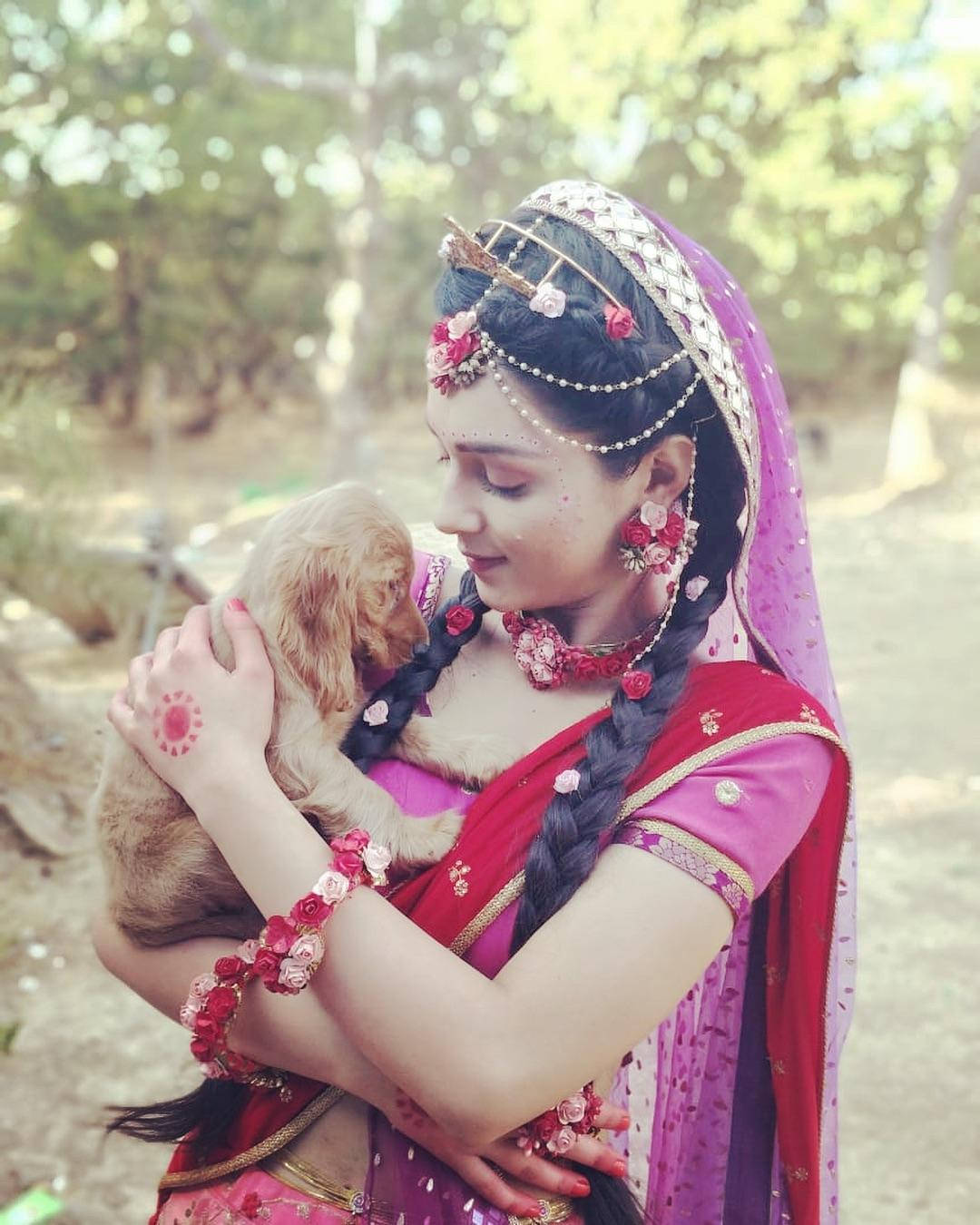 Mallika Singh Holding Dog Background