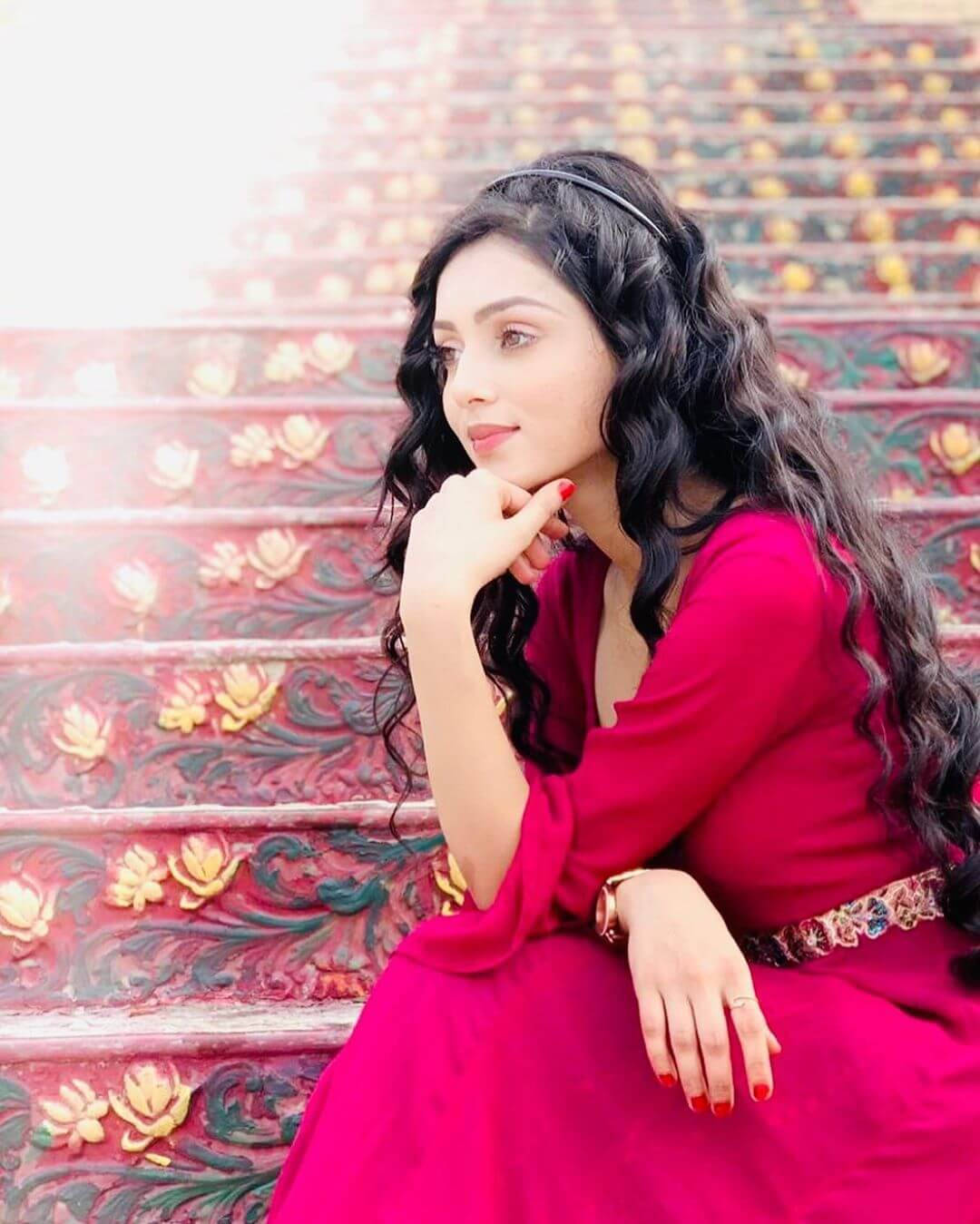 Mallika Singh Red Dress Stairs Background