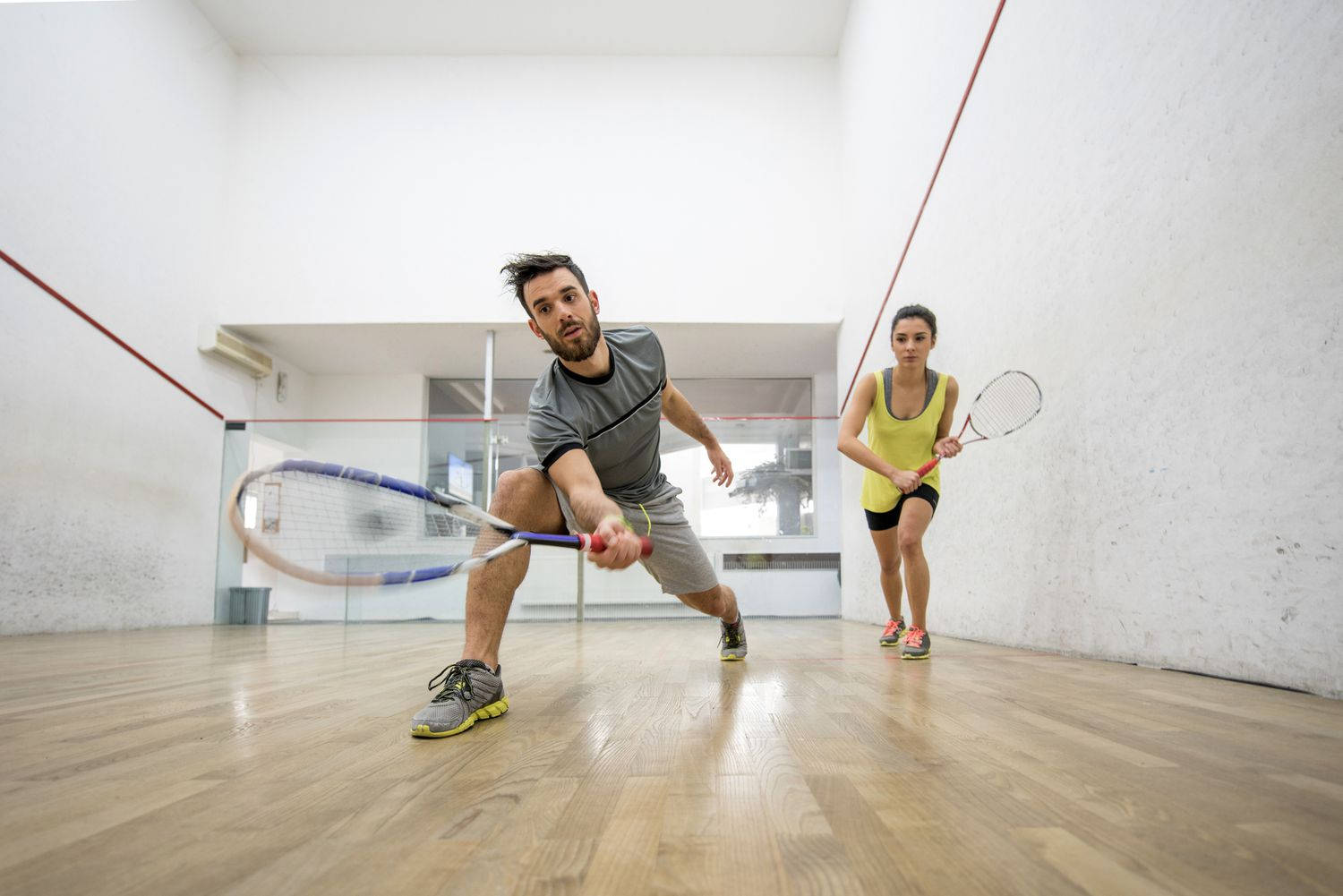 Man And Woman Team Playing Racquetball Background