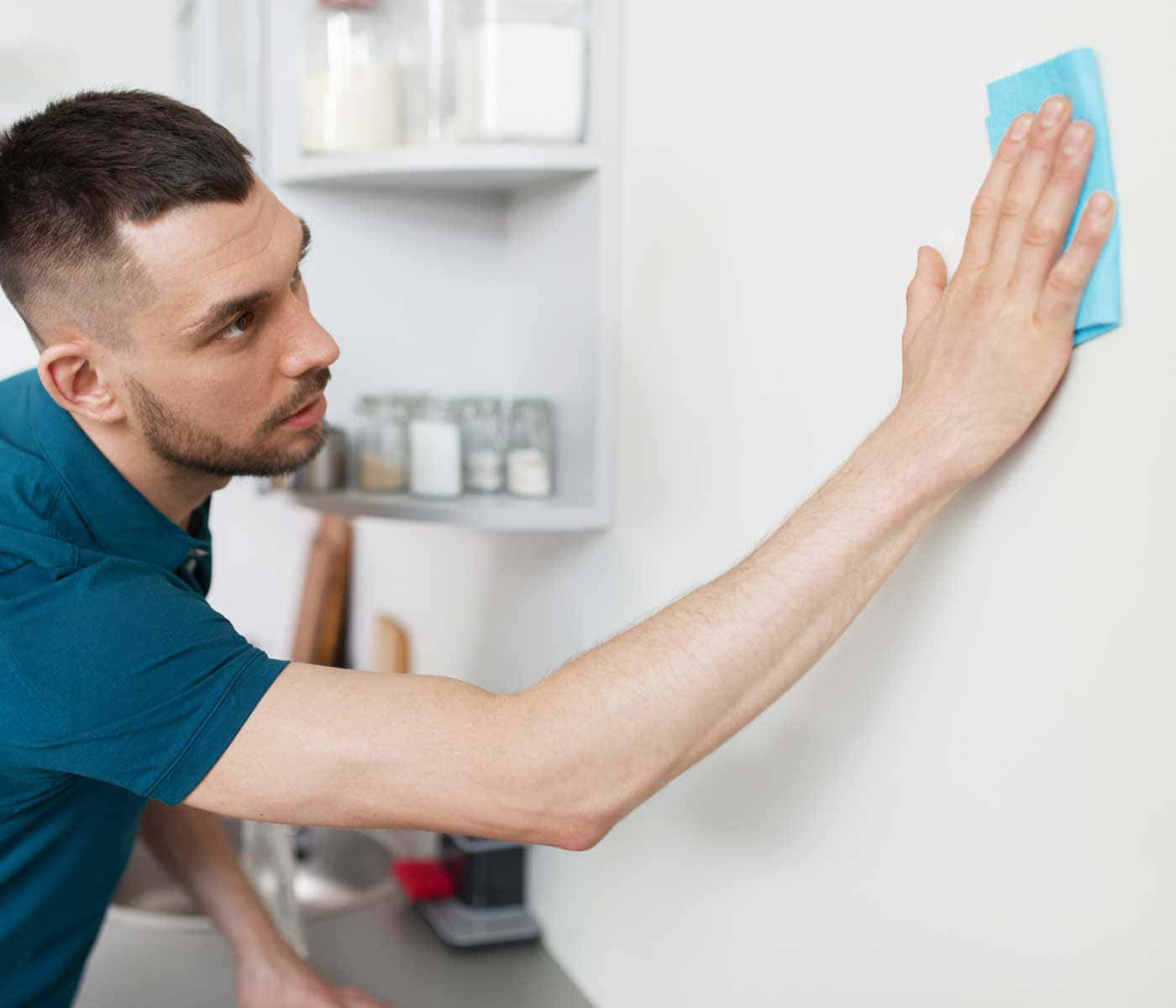 Man Cleaning White Wall Background