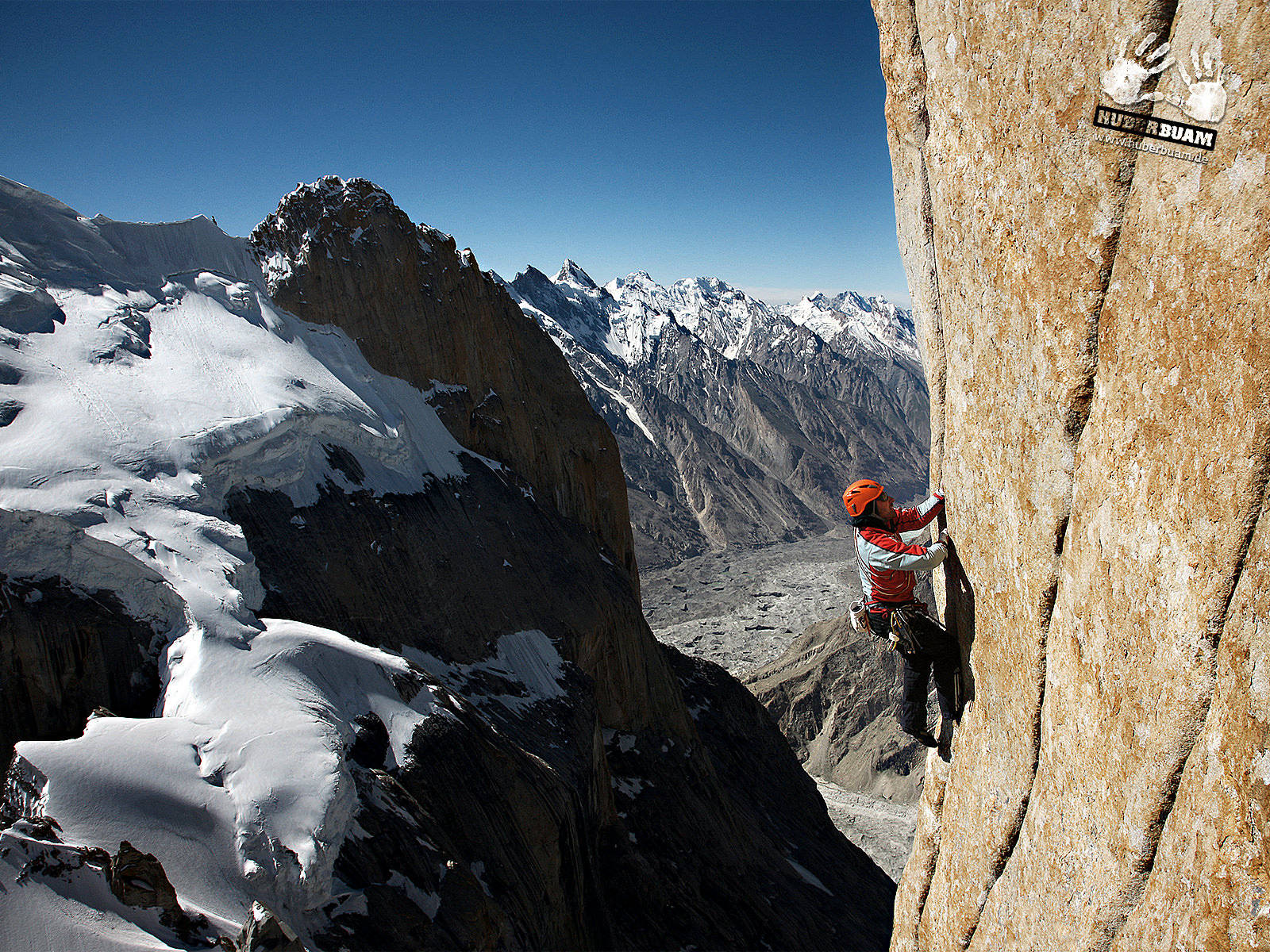 Man Climbing On A Snowy Rock Mountain Background