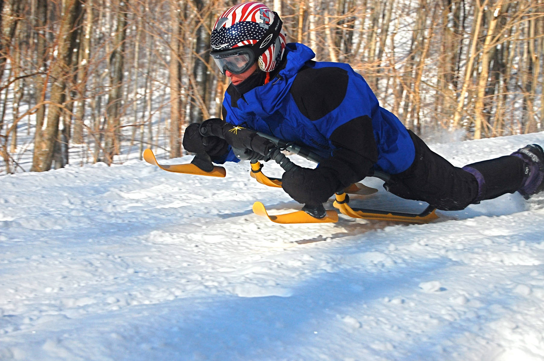 Man Crouch Sledding