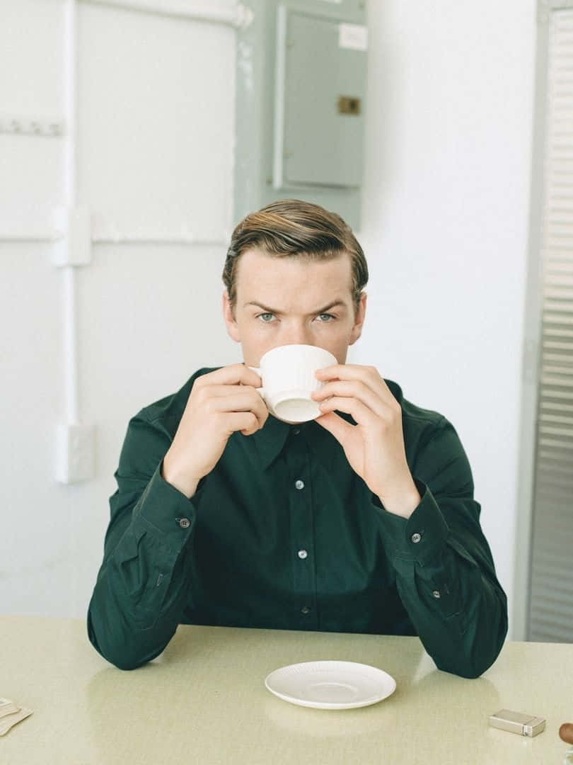 Man Drinking Coffeeat Table Background