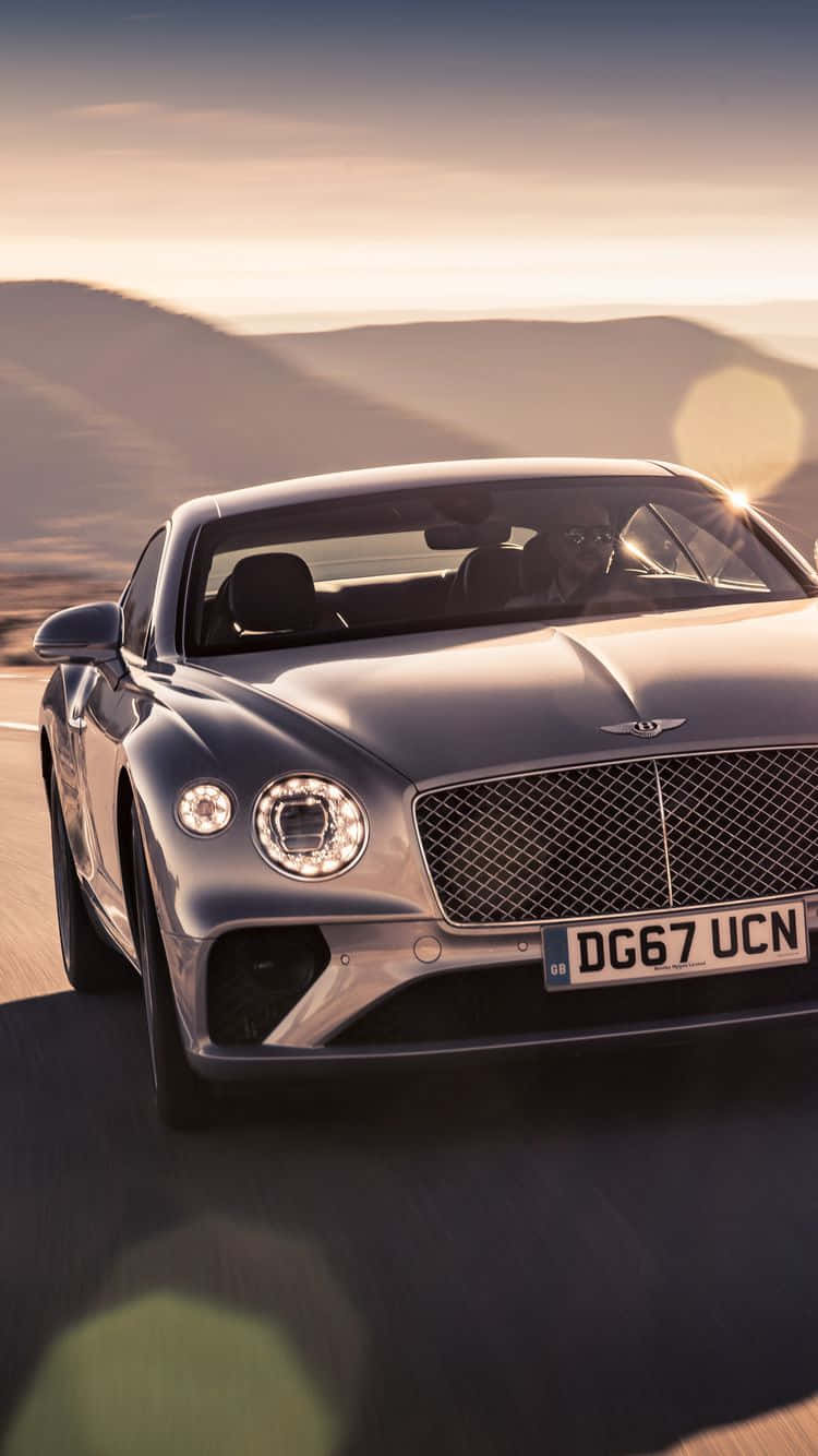 Man Driving A Bentley Iphone Background