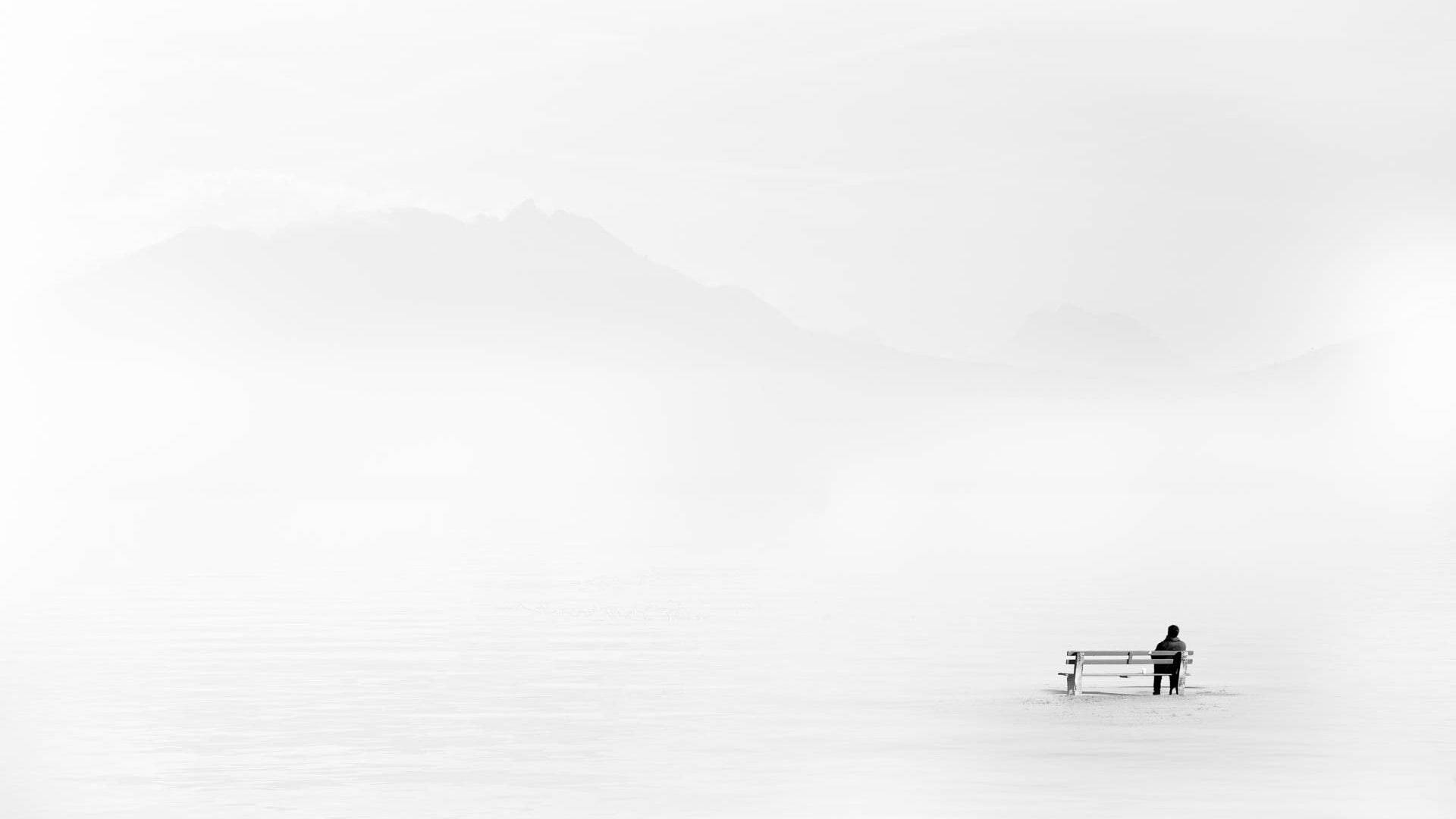 Man Embracing Solitude In Minimalist Setting Background