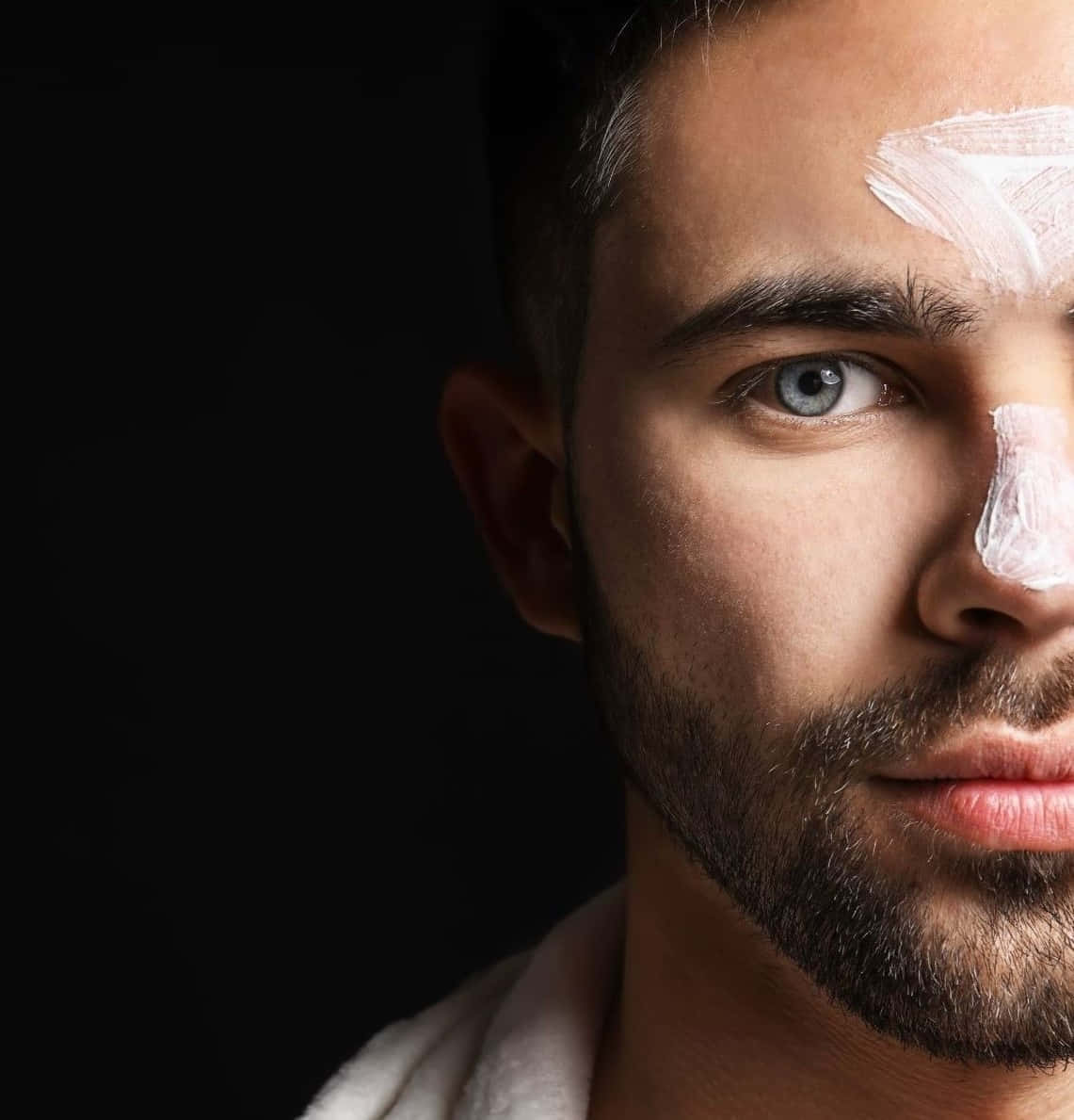 Man Face With Facial Cream Background