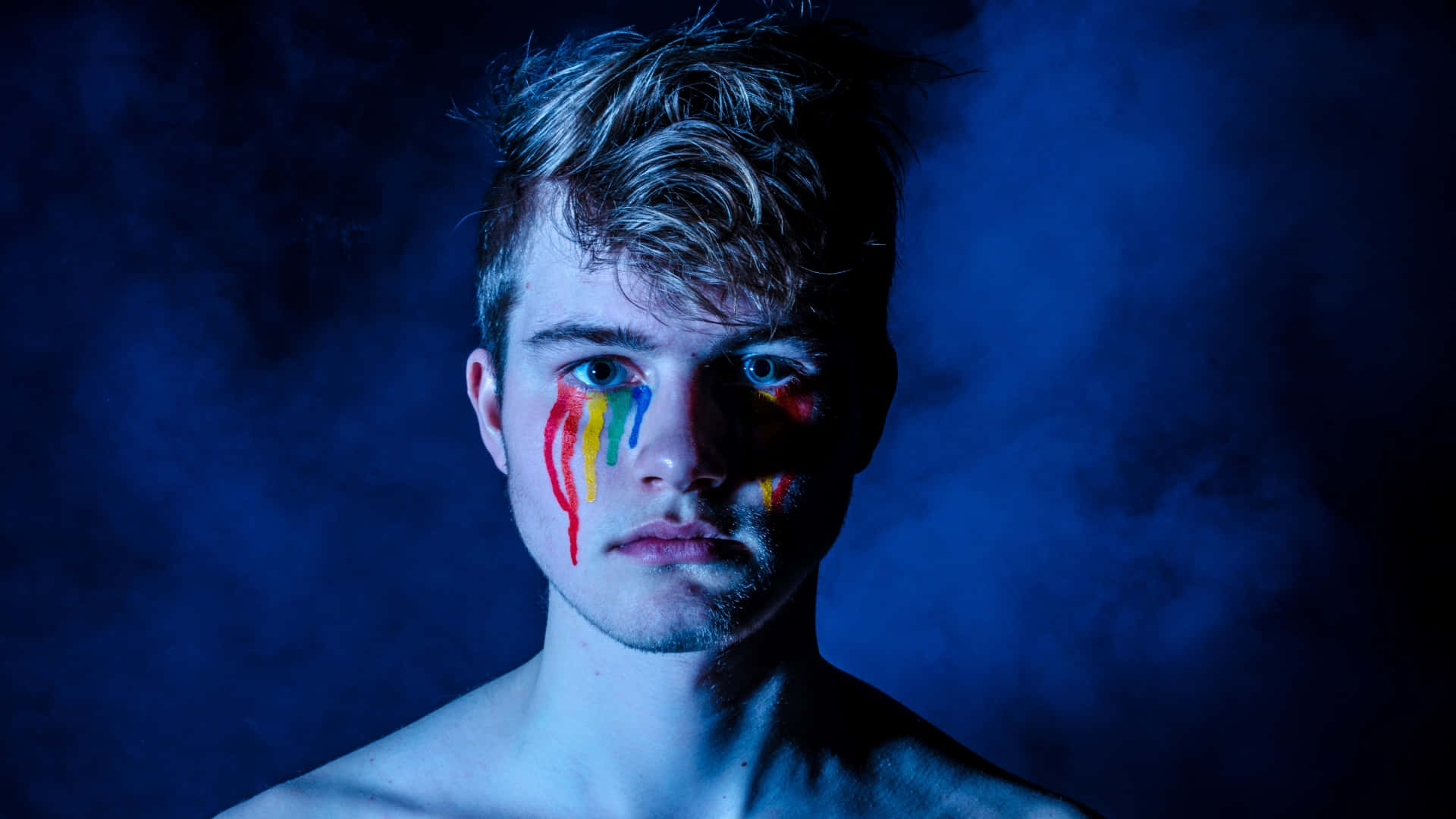 Man Face With Rainbow Facepaint Background