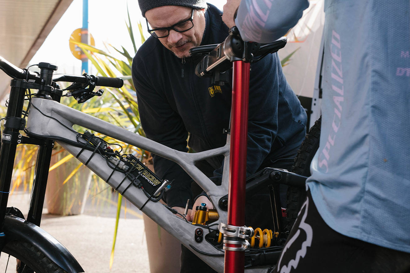 Man Fixing Specialized Bike Background