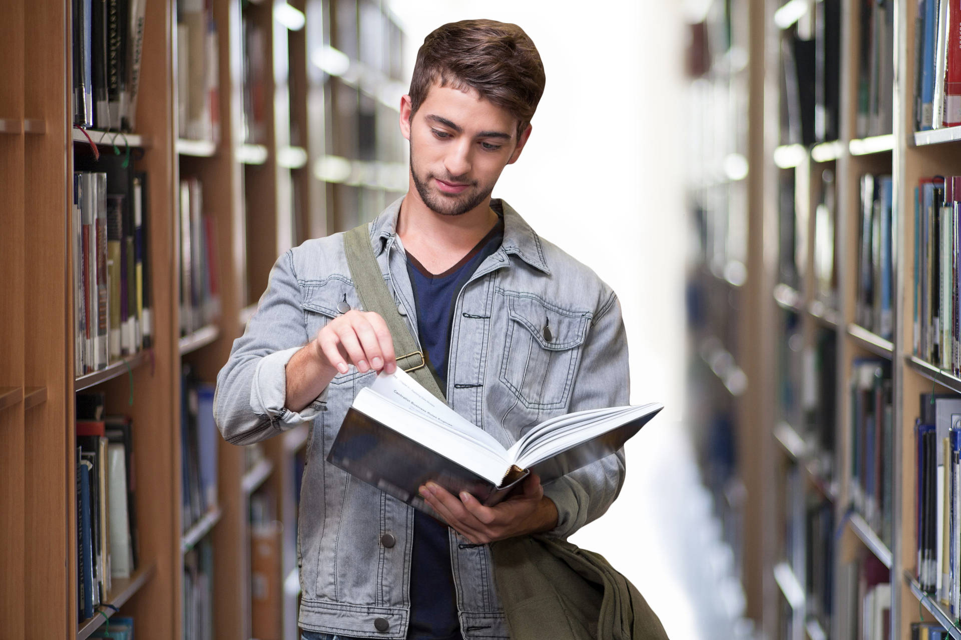 Man Flipping Through A Reference Book Background