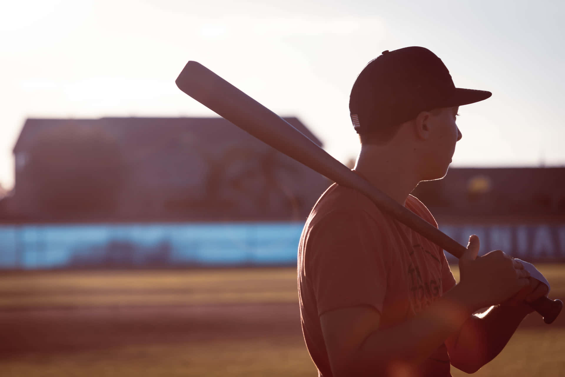 Man Gripping A Baseball Bat Ready For Action Background