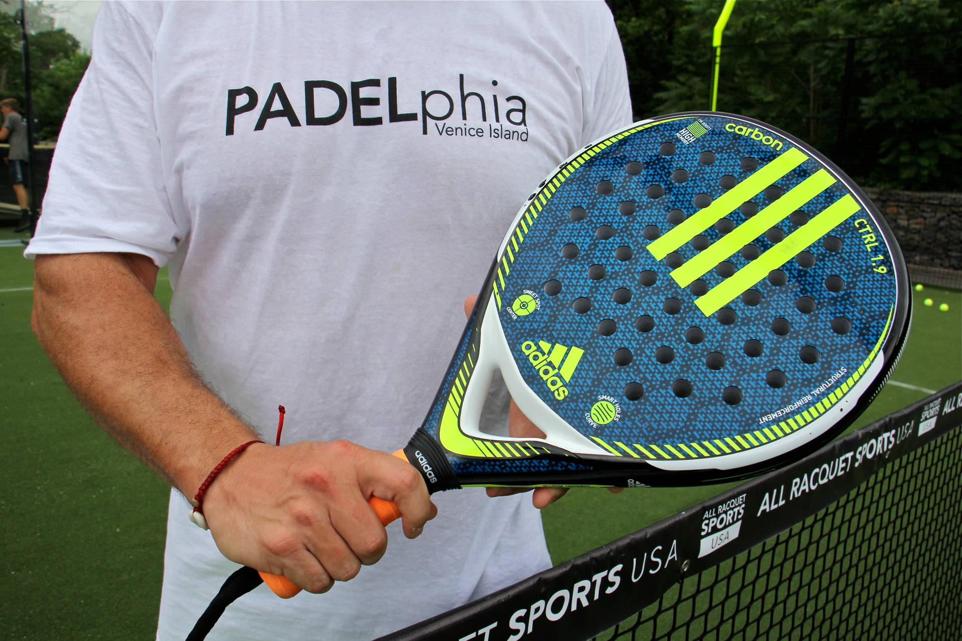 Man Holding Adidas Racquetball Racket Background