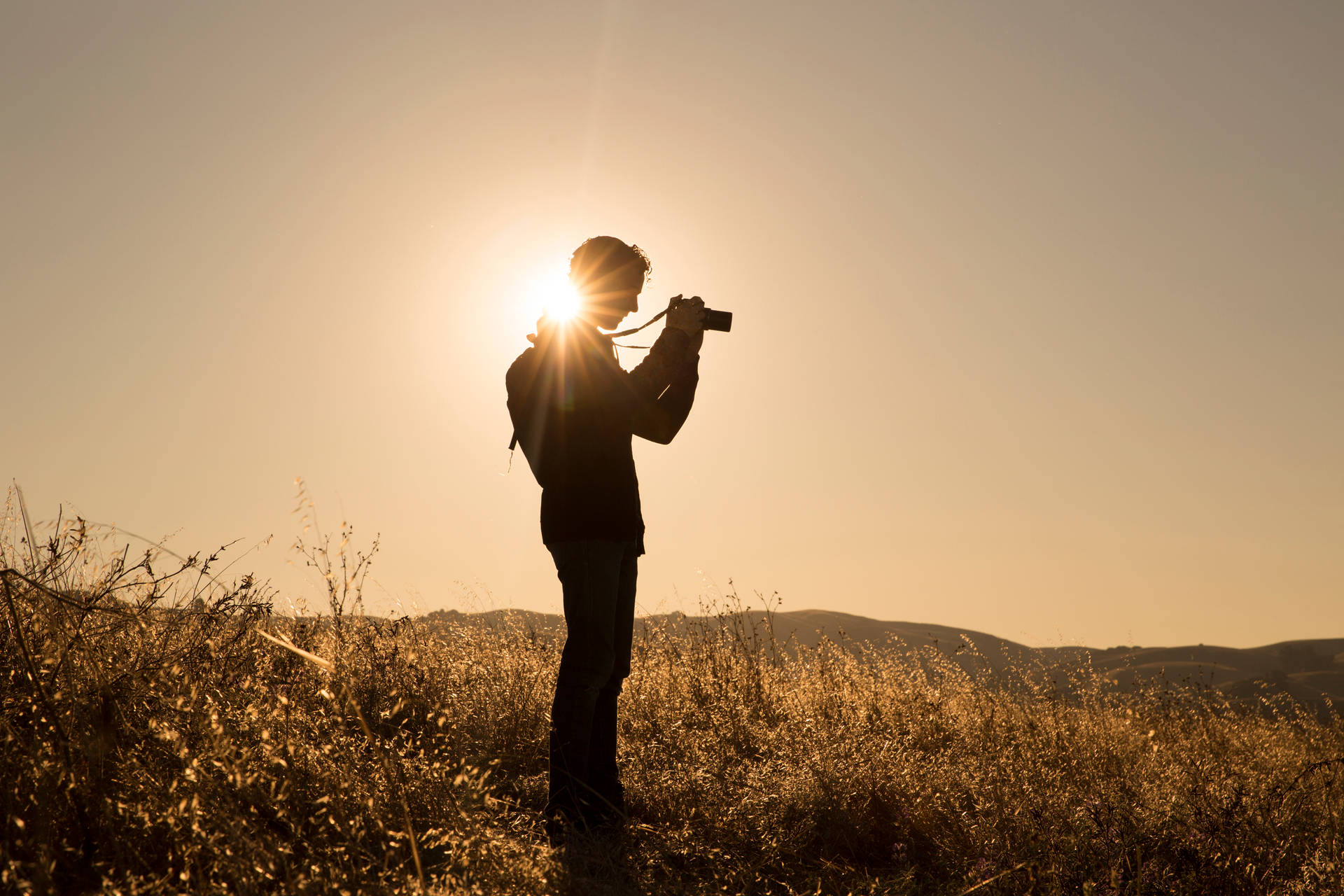 Man Holding Camera During Sunrise Photography Background