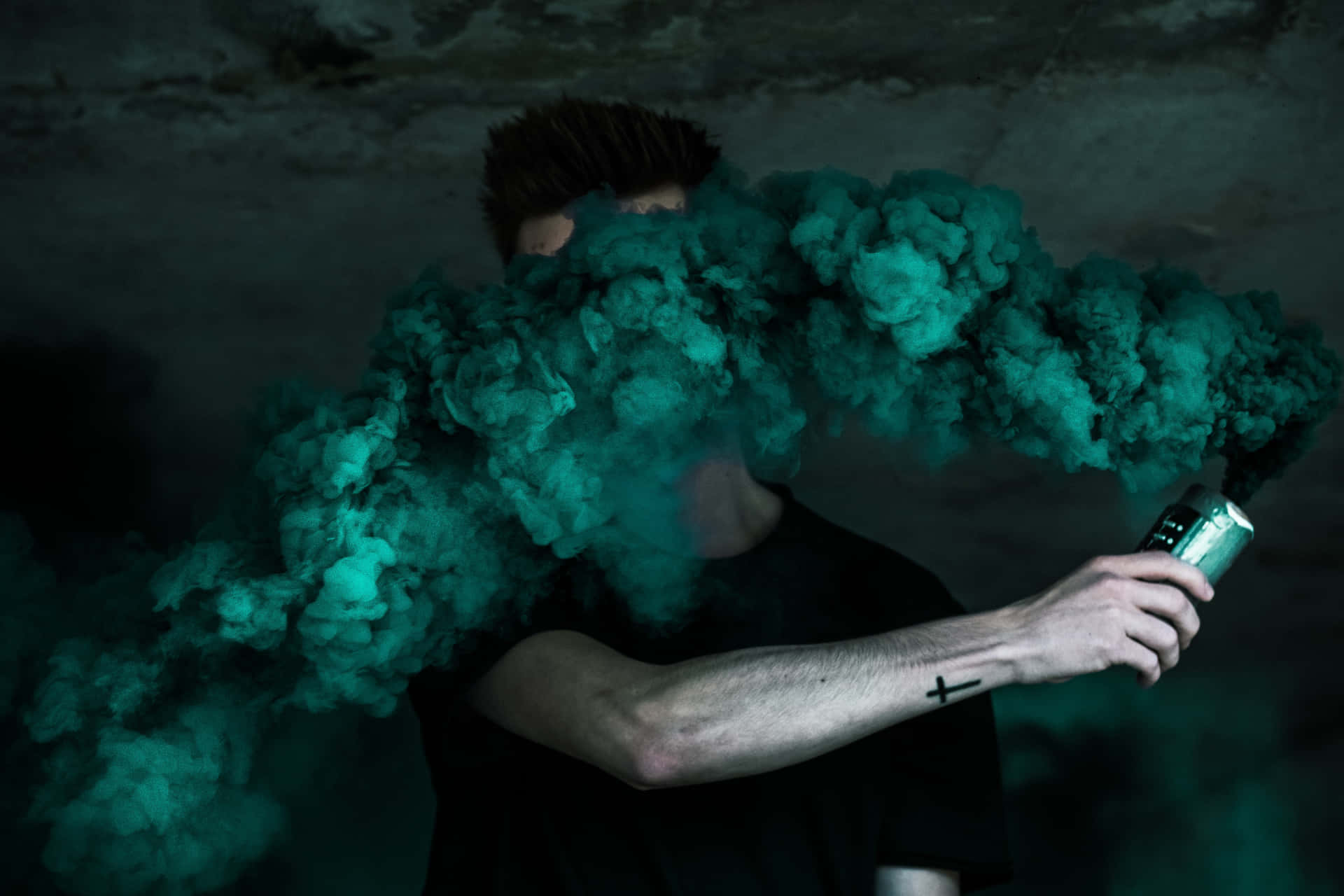 Man Holding Intense Green Smoke Bomb Background