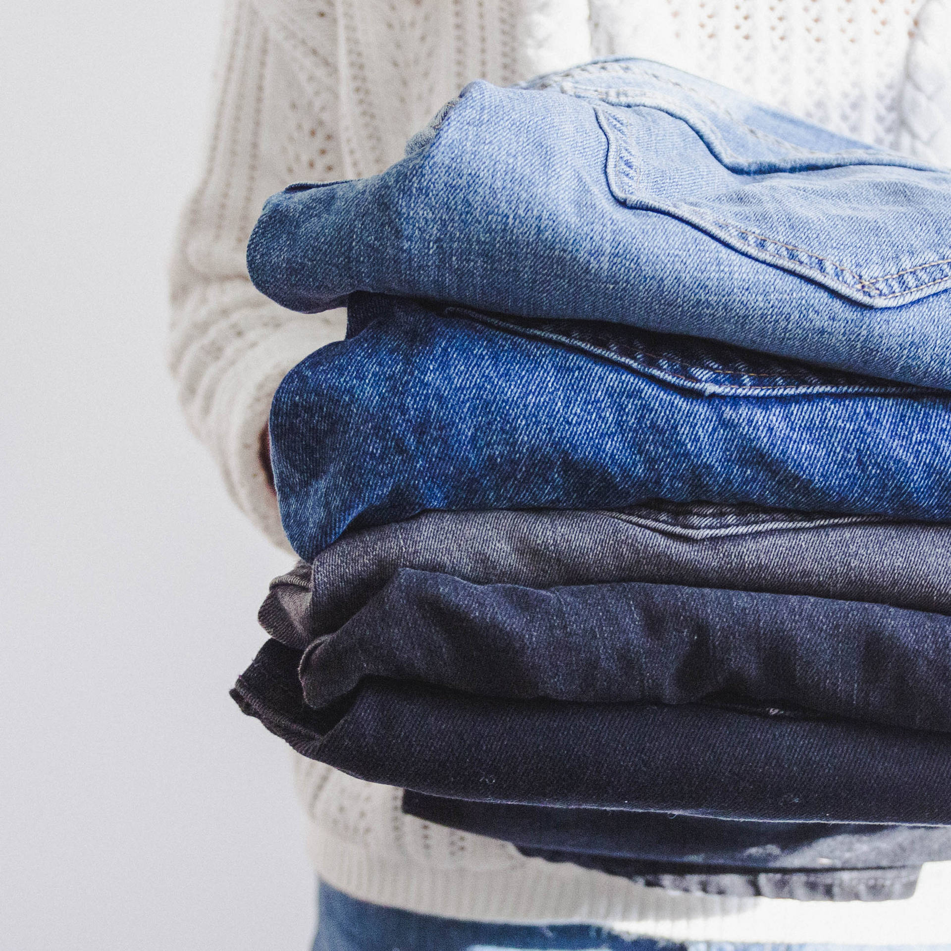 Man Holding Pair Of Jeans Background