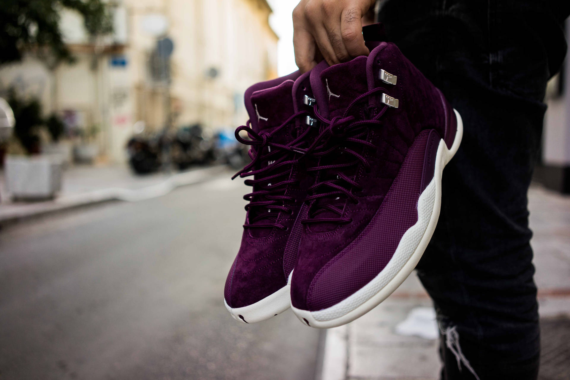 Man Holding Purple Sneakers Background