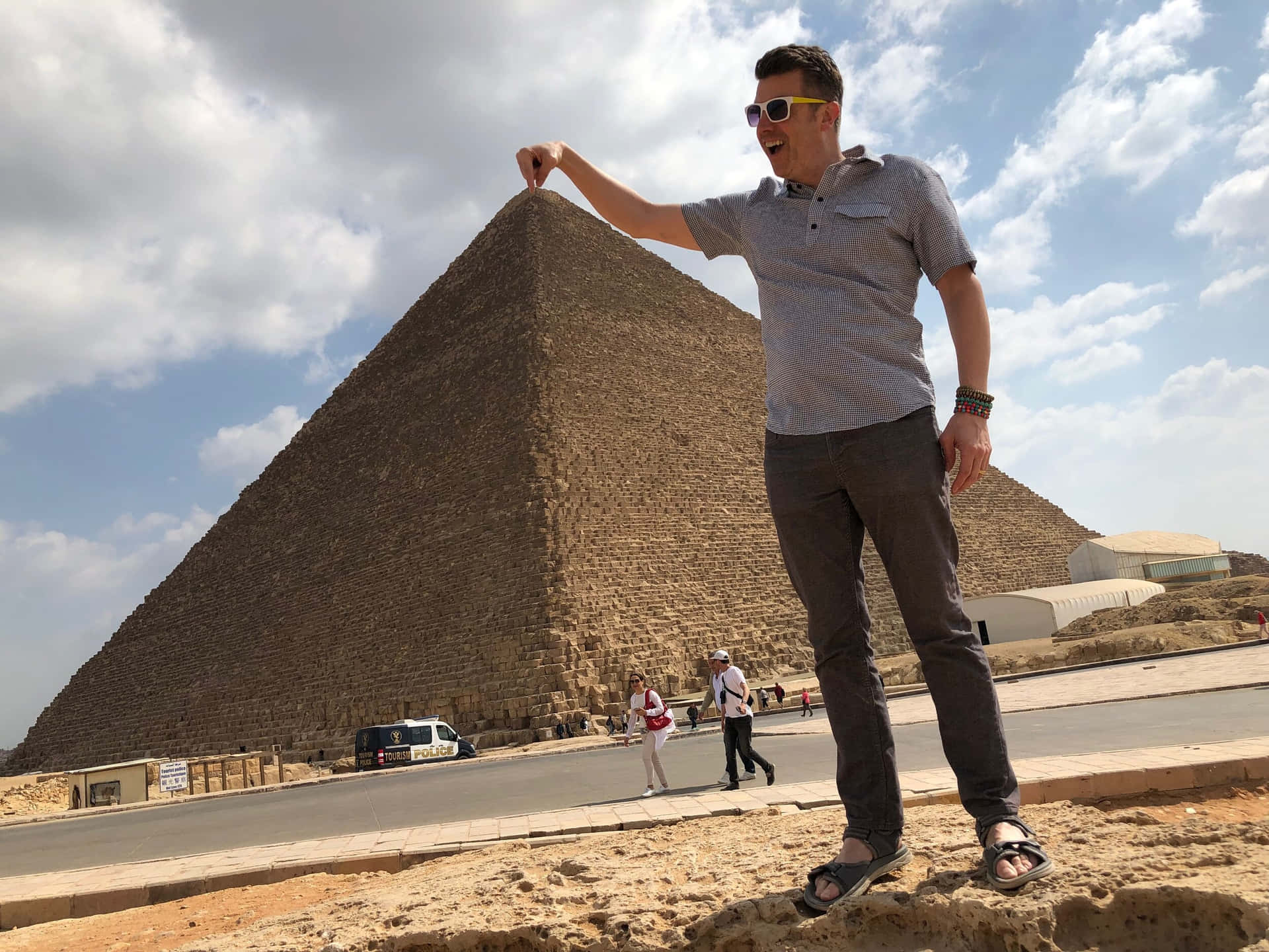 Man Holding The Tip Of The Pyramids Of Giza Background