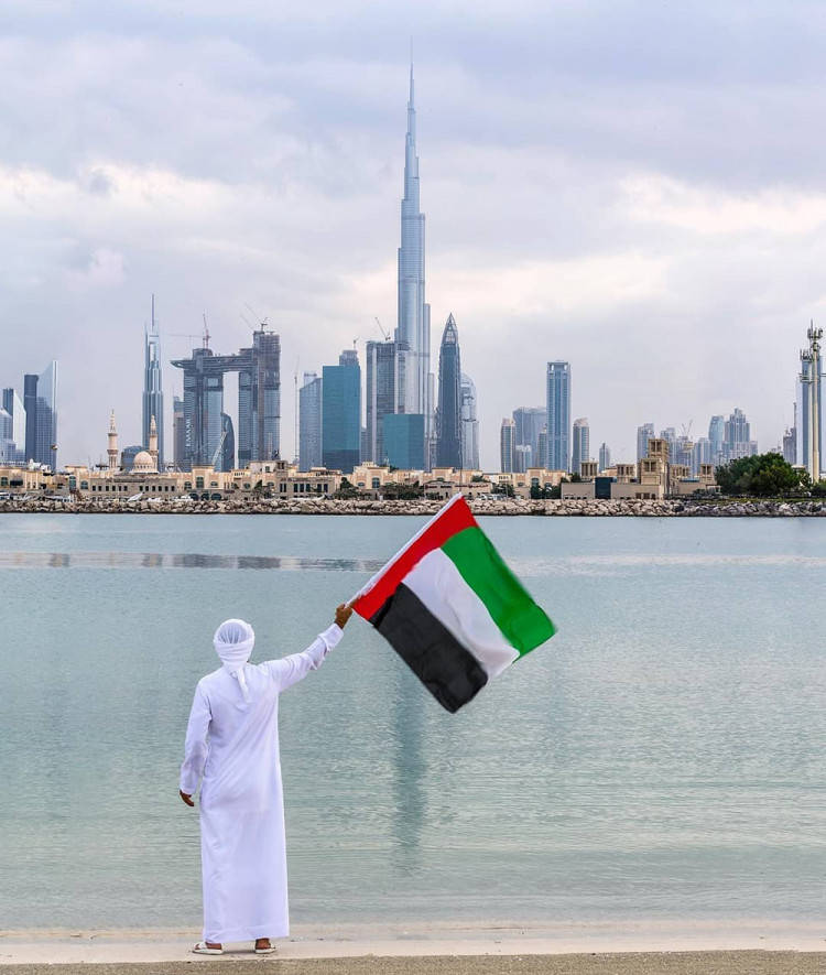 Man Holding Uae Flag Background