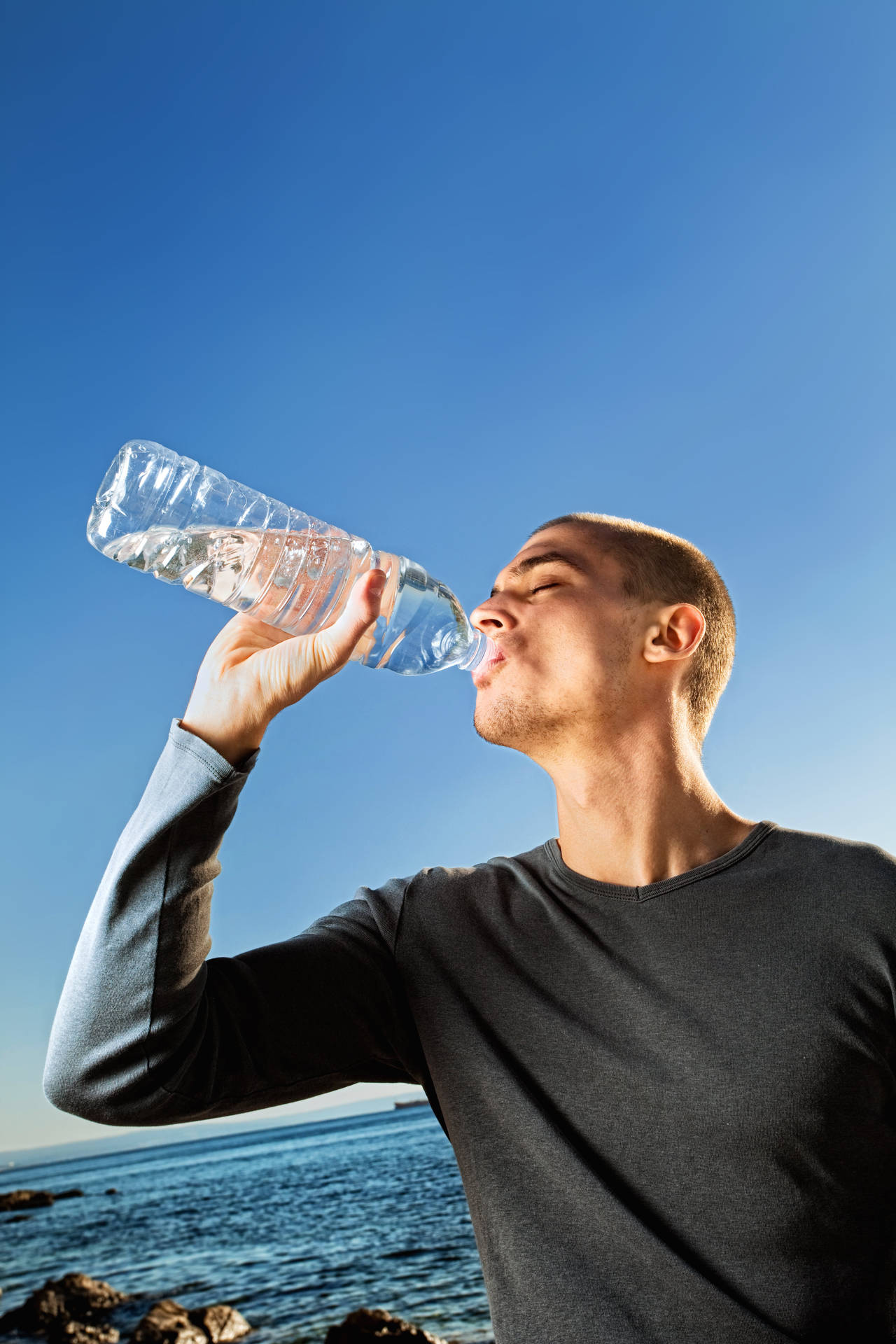 Man Hydrating With Bottled Water Background