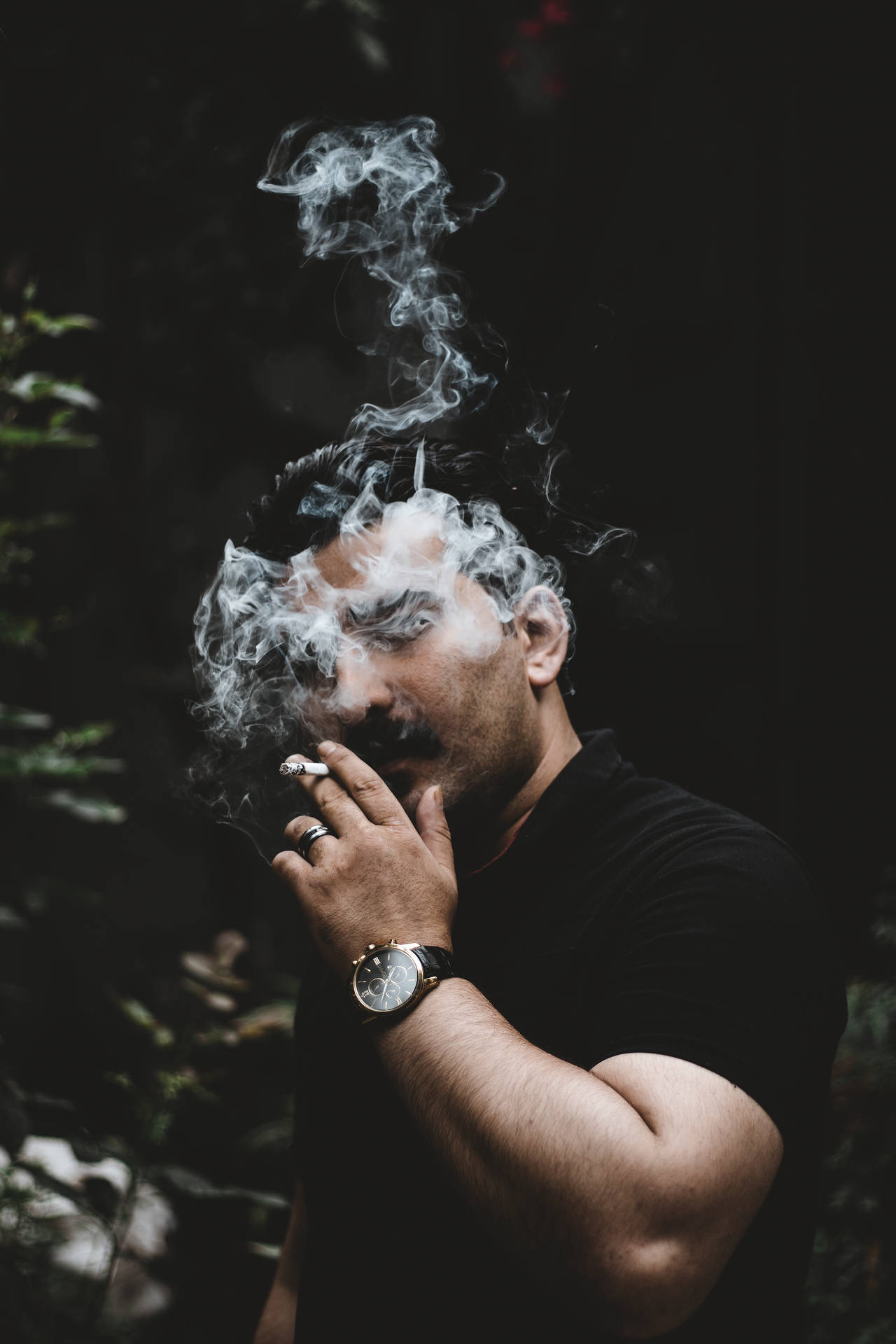 Man In Black Smoking Background