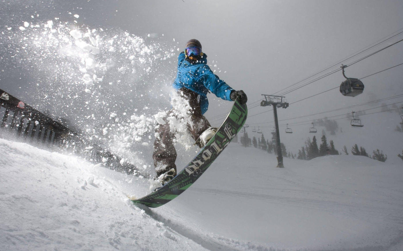 Man In Blue With A Snowboard Leaping