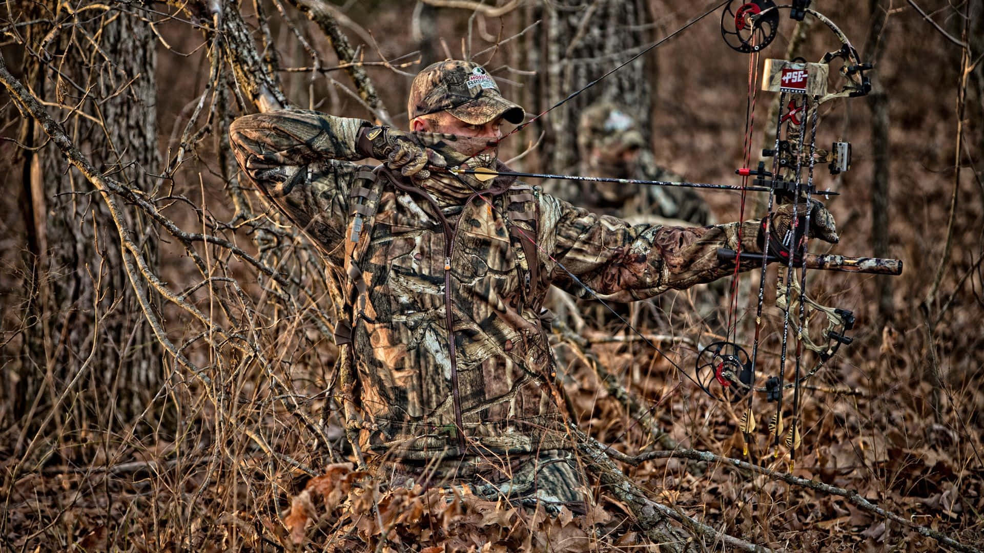 Man In Hunting Camo On Dried Leaves