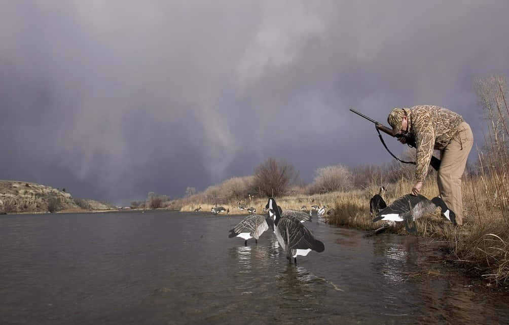 Man In Hunting Camo Petting Duck Background