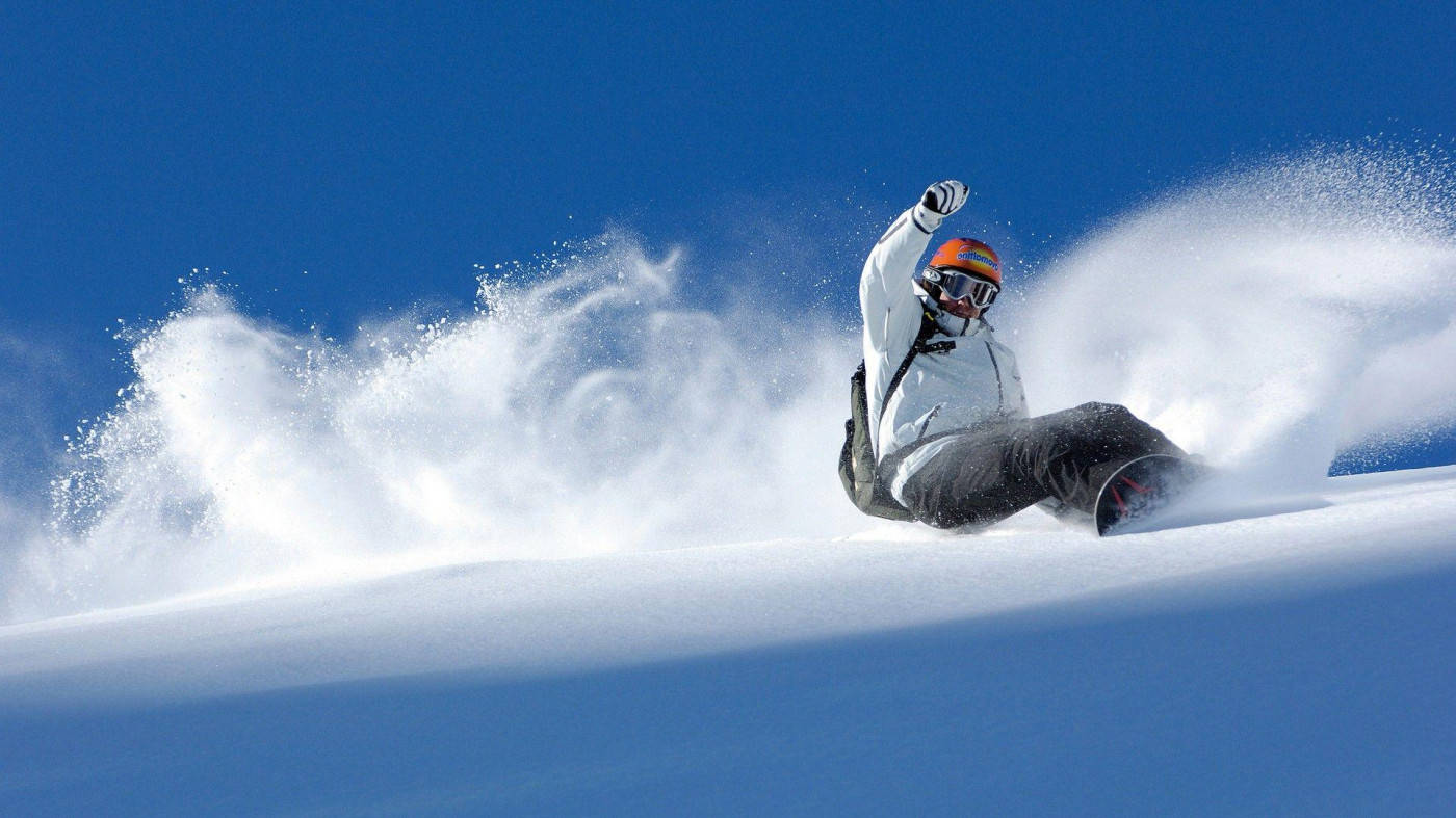 Man In Orange And White With Snowboard