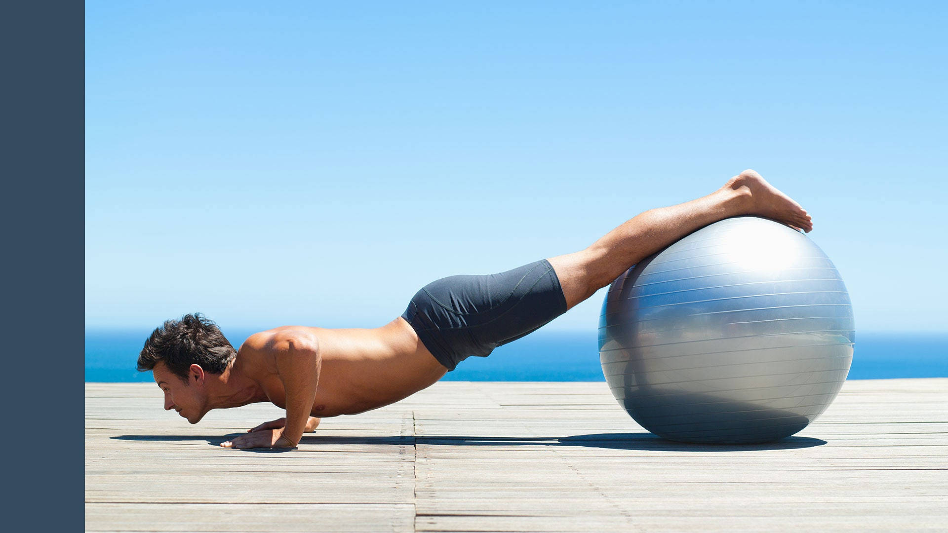 Man In Pilates With Metallic Ball Background