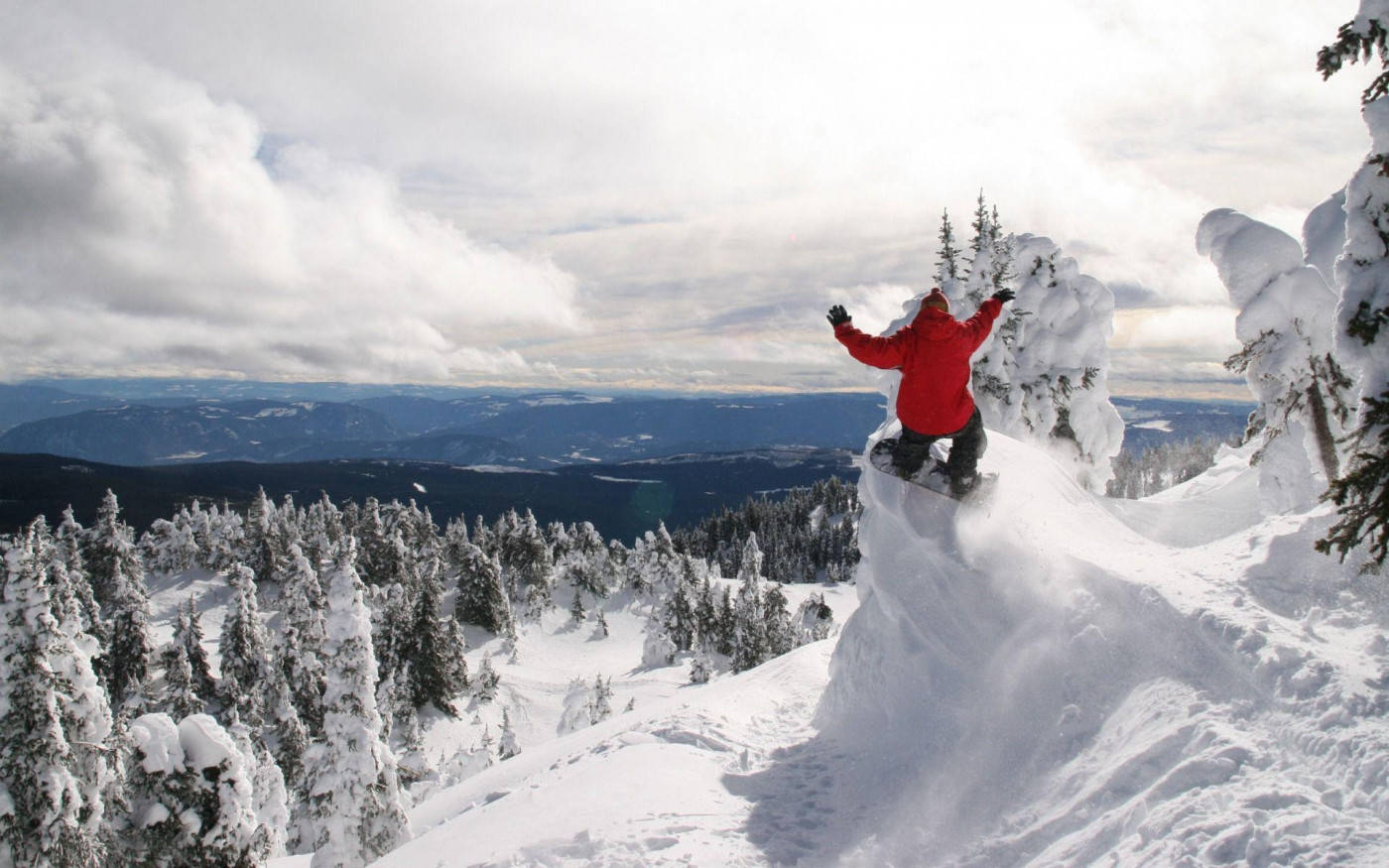 Man In Red With A Snowboard Leaping Background