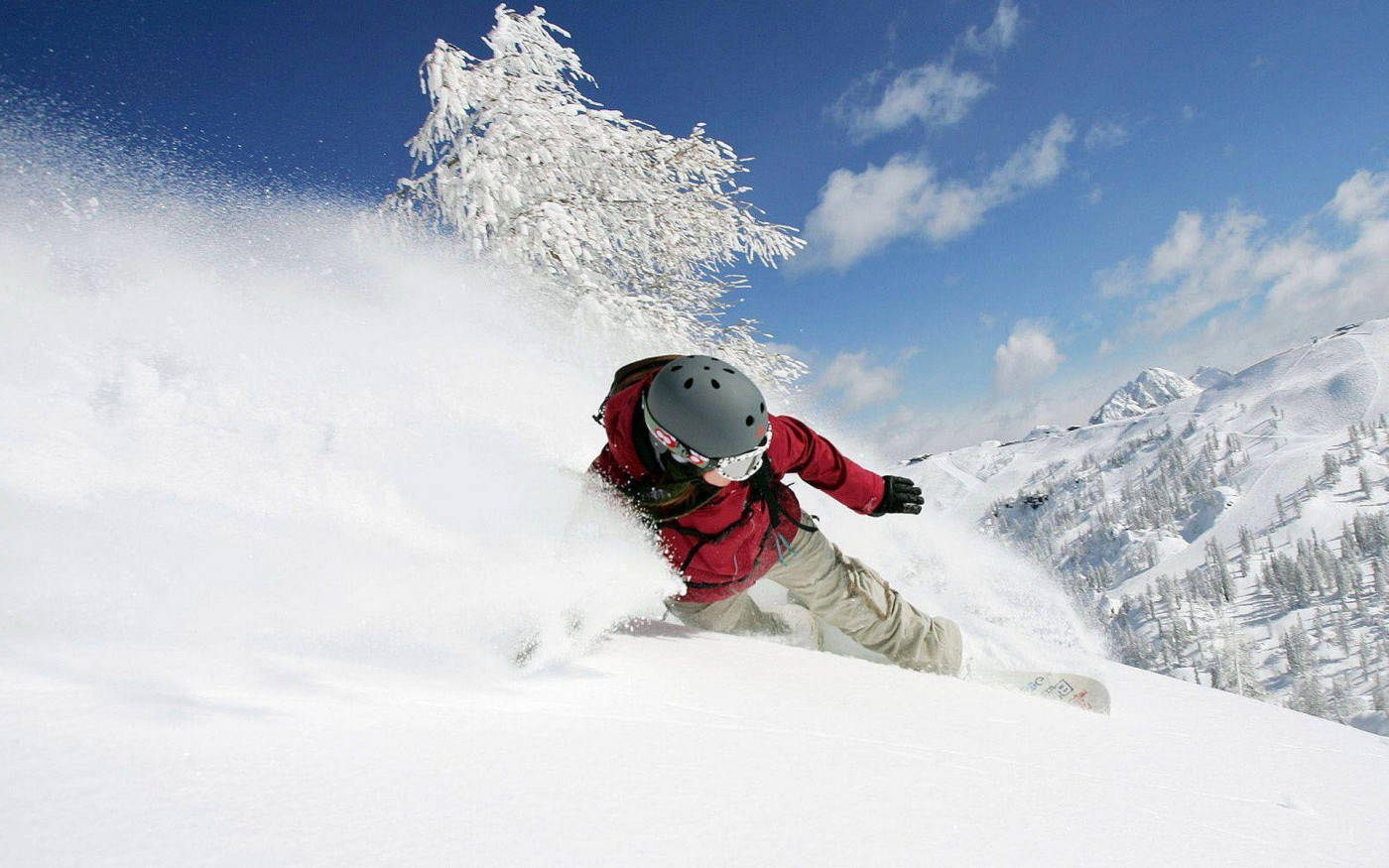 Man In Red With Snowboard Dashing Through Snow