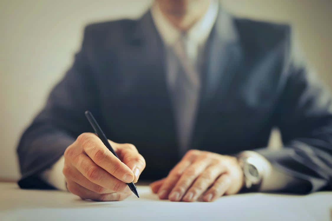 Man In Suit Signing Contract Documents Background