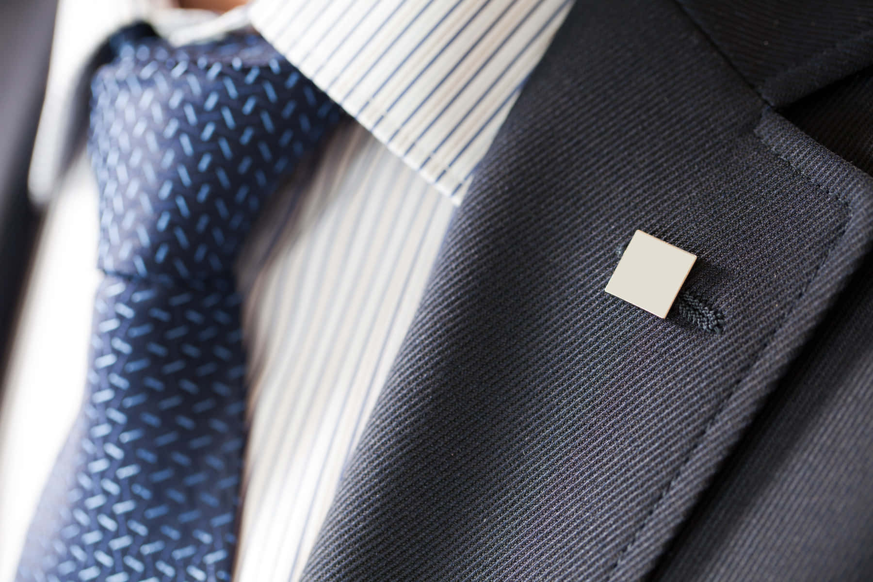 Man In Suit With Square Pin Background