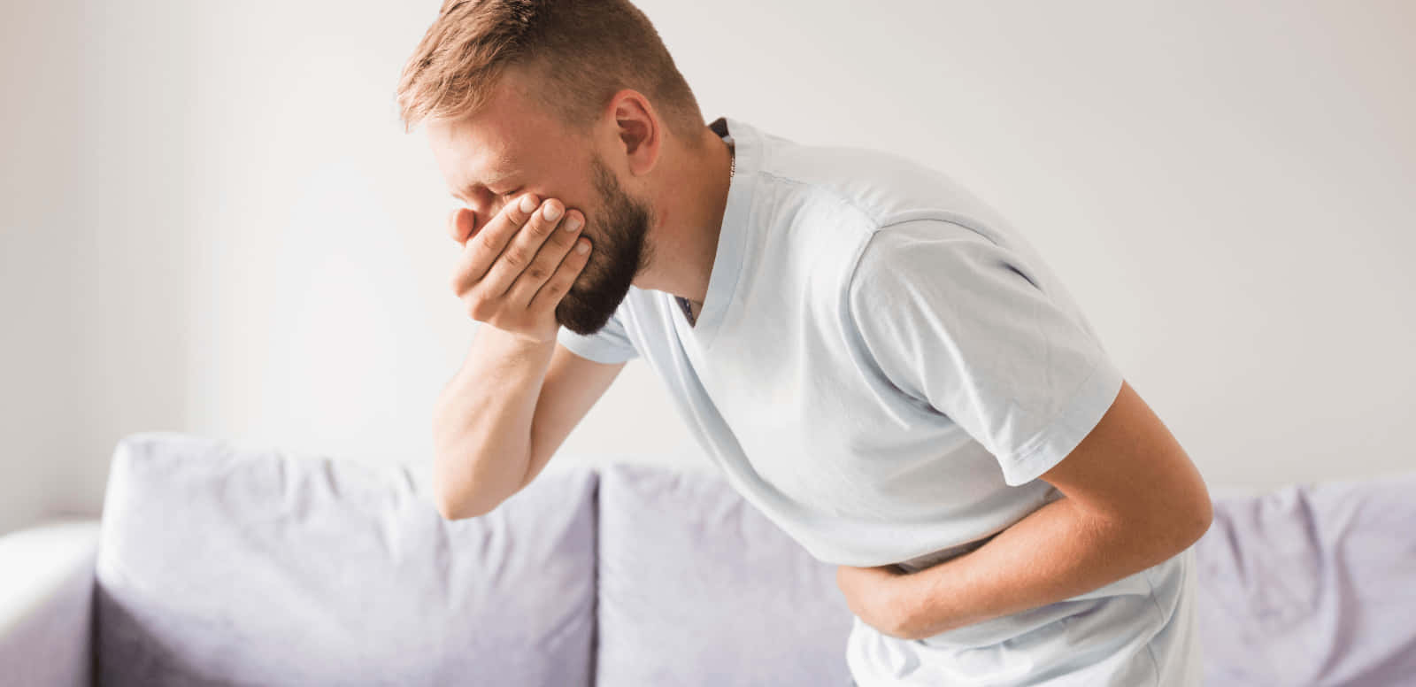 Man In White Shirt Feeling Nauseous