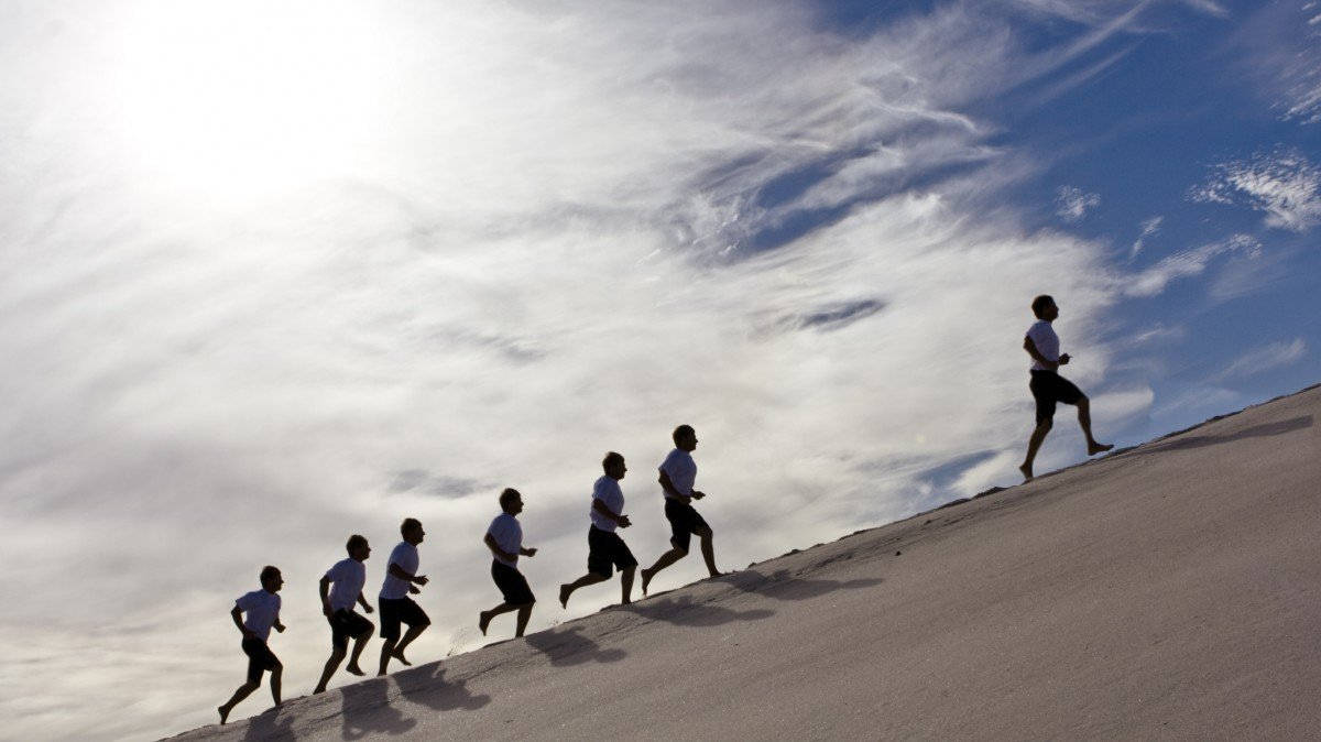 Man Lead Others Up A Hill