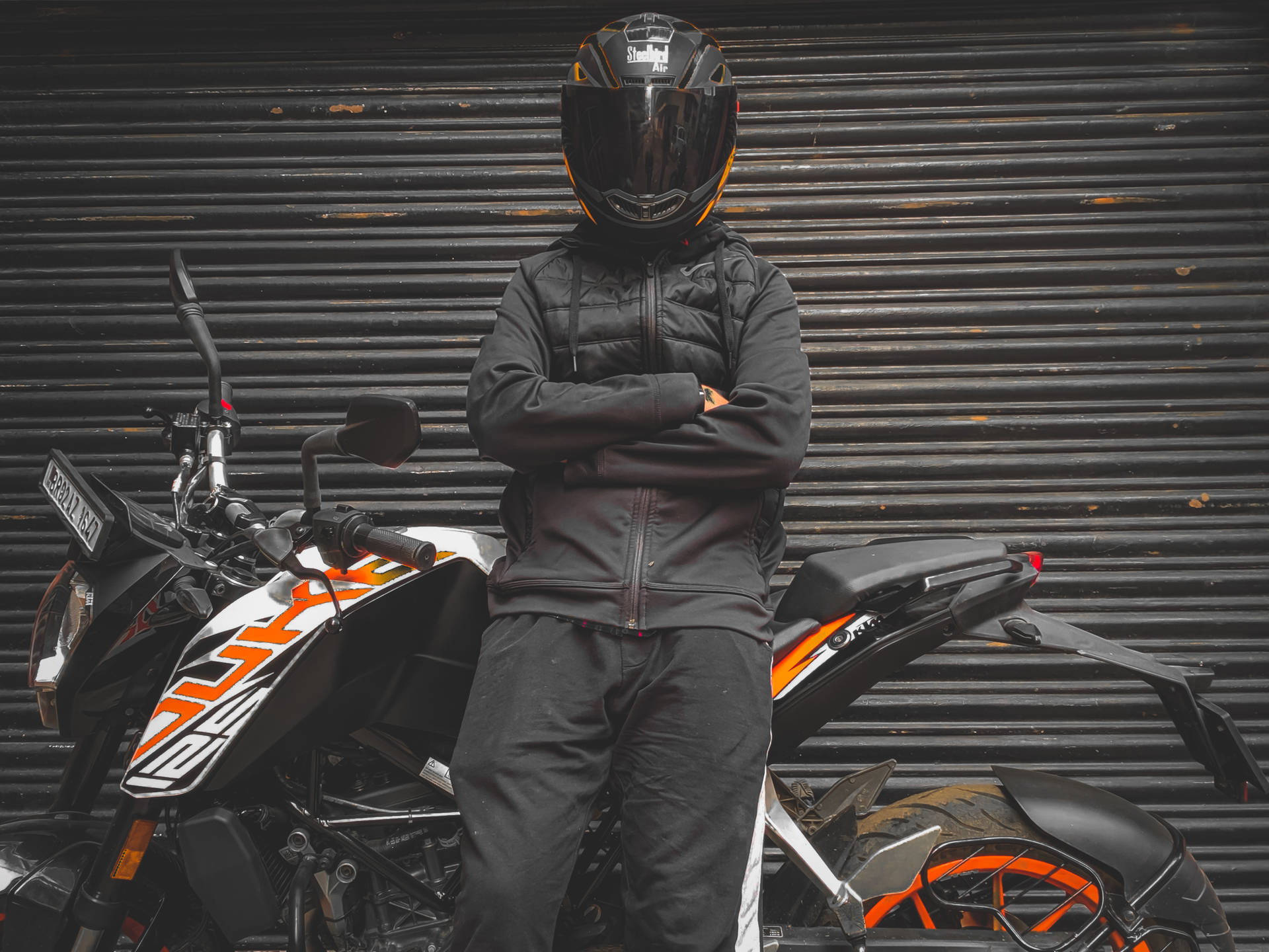 Man Leaning On A Ktm Duke 200 Background