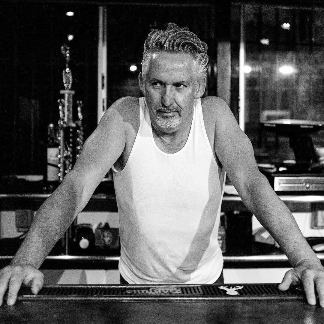 Man Leaningon Piano B W Background