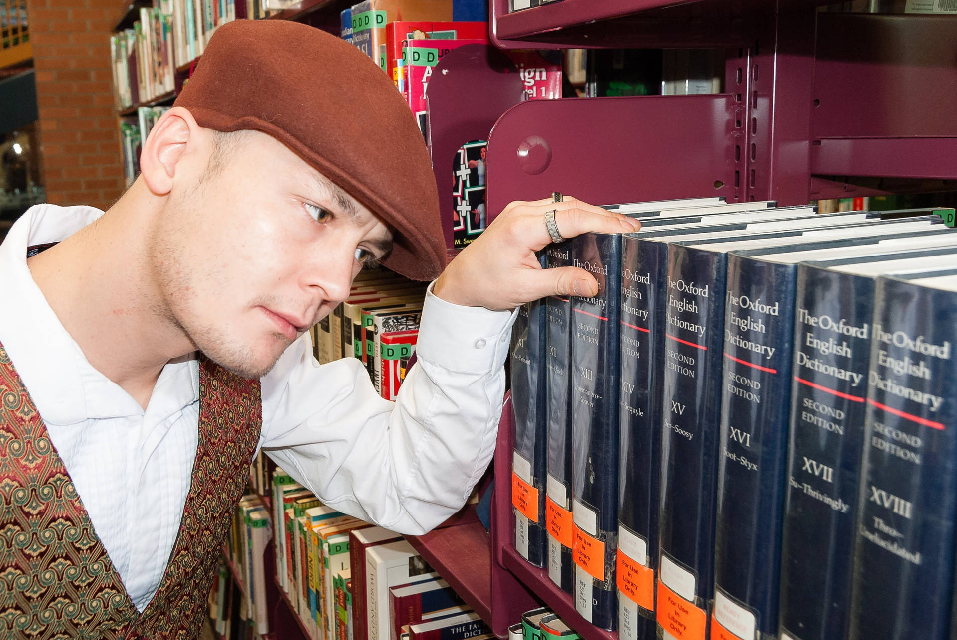 Man Looking At Oxford Dictionary Reference