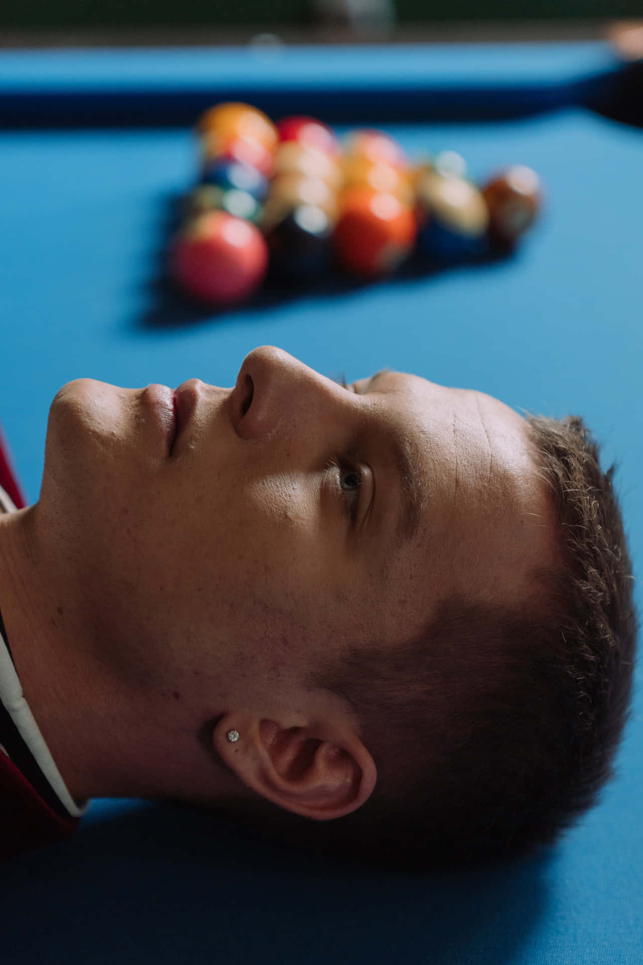 Man Lying On Pool Table